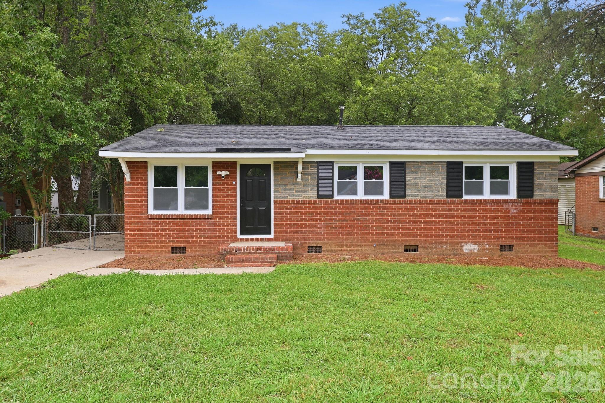 Fully renovated and move-in ready, this charming 3-bedroom, 1-bath brick ranch combines modern updates with an unbeatable location just minutes from I-77. Inside, you'll love the dark hardwood floors, fresh paint, and beautifully remodeled kitchen featuring white shaker cabinetry, stainless steel appliances, black fixtures, and a clean, timeless design.

Out back, the large fenced yard is what truly sets this home apart. Surrounded by mature trees, it offers plenty of shade, privacy, and room to entertain, garden, or simply relax on the deck. Ideally situated near Beatties Ford Road and Sunset Road, this home offers easy access to I-77 for a quick commute to Uptown Charlotte and surrounding areas. Enjoy the outdoors with Hornets Nest Park and the McIntyre Creek Greenway just a short walk away, featuring miles of trails, sports fields, playgrounds, and open green space. Shopping, dining, grocery stores, and other everyday essentials are all just minutes from your doorstep. Whether you're a first-time homebuyer, downsizing, or looking for an investment property, this home checks all the boxes with updated finishes, a functional layout, and easy access to Uptown Charlotte, shopping, restaurants, and major highways.