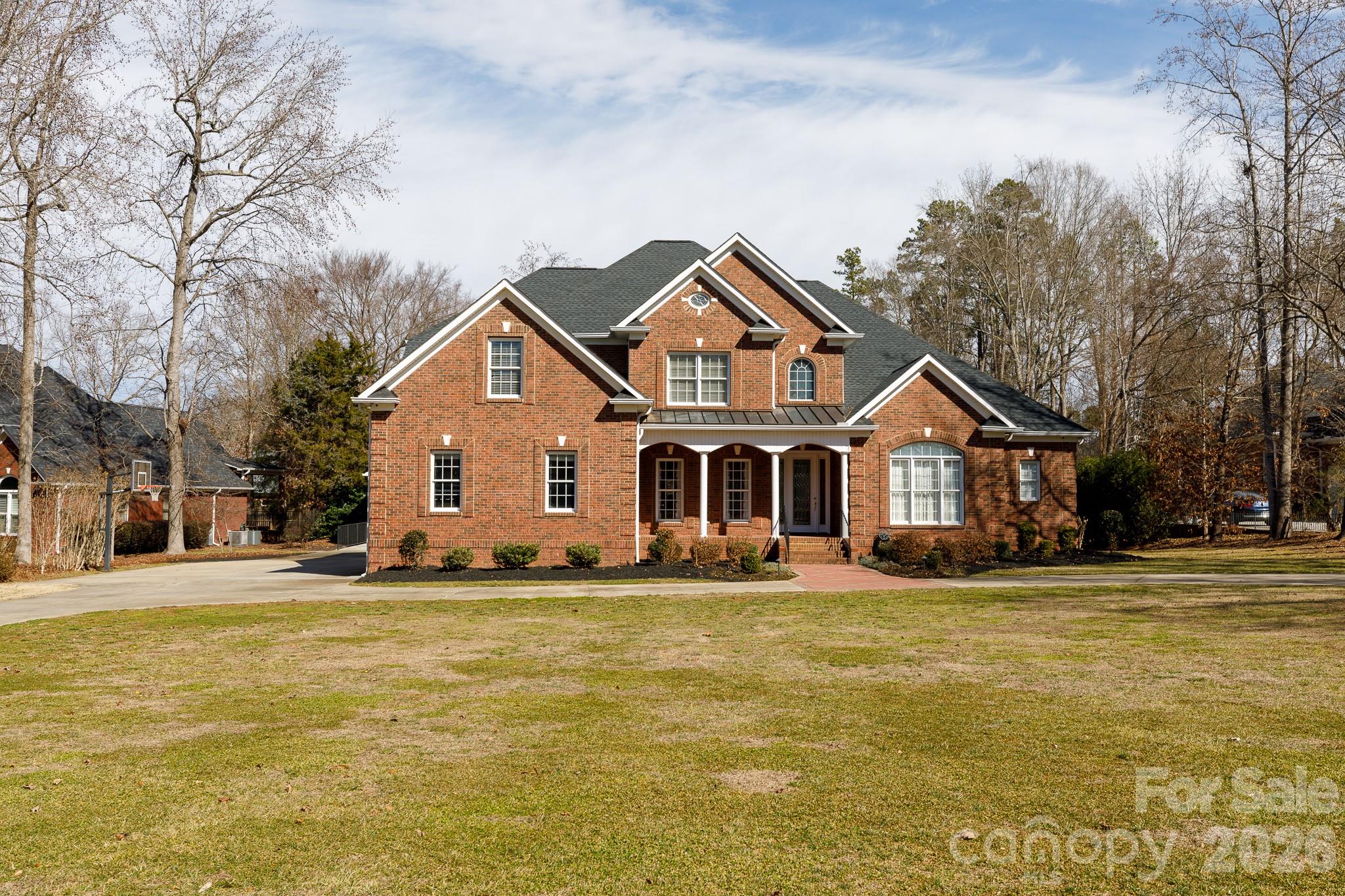 Imagine spending your summer afternoons lounging by your private, heated saltwater pool, surrounded by the elegance of a brick privacy fence and the convenience of an outdoor kitchen. This stunning full-brick estate in Meadow Lakes II is designed for those who love to entertain, offering a seamless flow from the vaulted living room to the expansive screened porch with classic brick flooring. Whether you are hosting a formal dinner in the grand dining room or enjoying a quiet morning in the keeping room by the fire, every inch of this home exudes quality. Car enthusiasts or hobbyists will find their paradise in the massive, climate-controlled detached tandem garage, complete with a pool-accessible half bath. From the primary retreat on the main level to the community's tennis courts and ponds, this property offers a sophisticated lifestyle that balances luxury with every practical convenience, including a whole-house generator and a sprawling 0.84-acre lot.