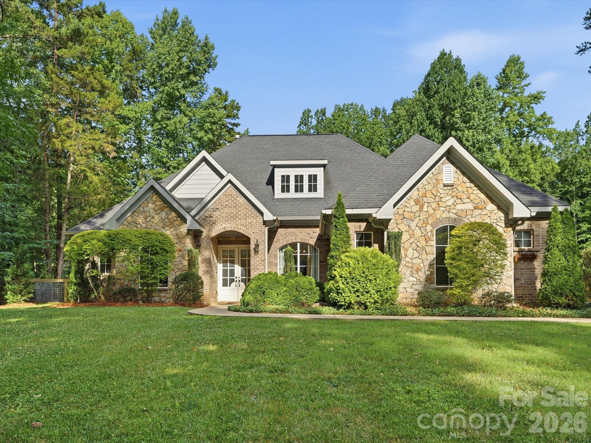 Welcome to 9831 Minnie Lemmond Ln, a home designed for comfort, entertaining, and everyday convenience. This property offers a thoughtful mix of indoor upgrades and outdoor functionality, making it stand out from the moment you arrive. Inside, you’ll find elegant coffered ceilings, a gas cooktop, a spacious laundry room with sink, and a relaxing primary suite featuring a soaking tub. The rec room with wet bar creates the perfect space for hosting, movie nights, or game-day gatherings. Outside, the home continues to impress with a hot tub included, an extended concrete area previously used for RV storage, and a gas connection ready for an exterior stove, grill, or future outdoor kitchen setup. The property also features a Generac generator connection, adding extra peace of mind and convenience for the next owner. With practical upgrades, great entertaining spaces, and features buyers are actively looking for, this home is one you’ll want to see in person. Schedule your showing and experience everything 9831 Minnie Lemmond Ln has to offer.
