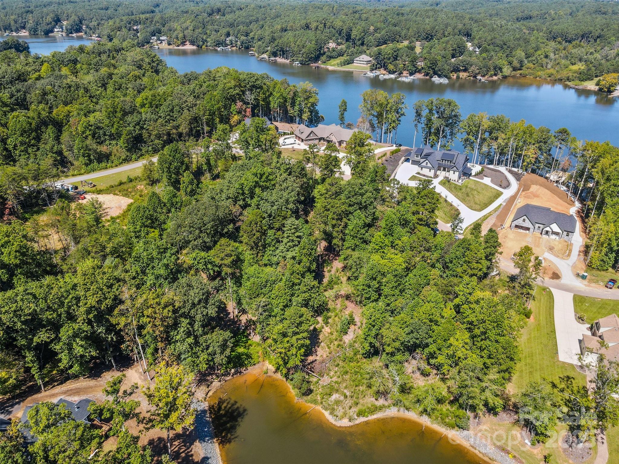 Nestled in the sought-after gated community of Waterfront Harbor, this 0.71-acre lot offers stunning views of Lake Hickory and the ideal setting for your dream home. With ample space to build and enjoy, you’ll love the blend of privacy, natural beauty, and access to all that lake living has to offer! Conveniently located near Hickory’s best shopping, dining, and everyday amenities, this lot combines the ease of modern living with the tranquility of a private lakeside retreat. Lake Hickory itself provides a long list of recreational opportunities - boating, swimming, fishing, kayaking, and more - so you can fully embrace the lake lifestyle right from your doorstep. Don’t miss this rare opportunity to create your perfect retreat in one of Hickory’s premier waterfront communities! Whether you’re looking for a full-time residence or a weekend escape, this property delivers the views, the location, and the lifestyle you’ve been searching for!