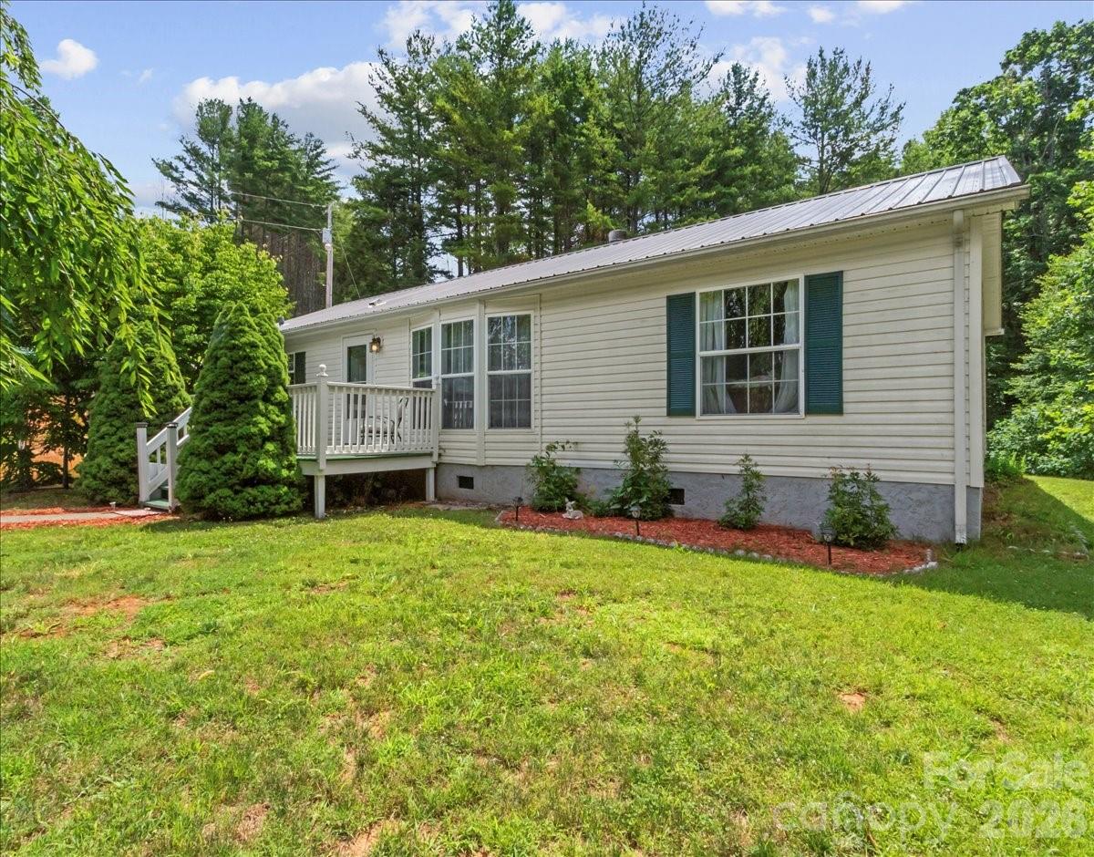 Welcome to 98 Cardinal Lane, where peaceful country living meets everyday convenience. This well-maintained 3-bedroom, 2-bath home sits on a beautiful 1-acre lot with a spacious yard, offering plenty of room for gardening, entertaining, or simply enjoying the mountain air.

Inside, you'll find a comfortable layout that's ready for you to make your own.

Conveniently located just minutes from downtown Burnsville, you'll enjoy easy access to local shopping, dining, and outdoor recreation, while being only a short drive to Asheville, NC, and Johnson City, TN. Best of all, there are no HOA fees and no restrictions, giving you the freedom to use and enjoy your property your way.

Don't miss your opportunity to own this charming home in the heart of Western North Carolina!