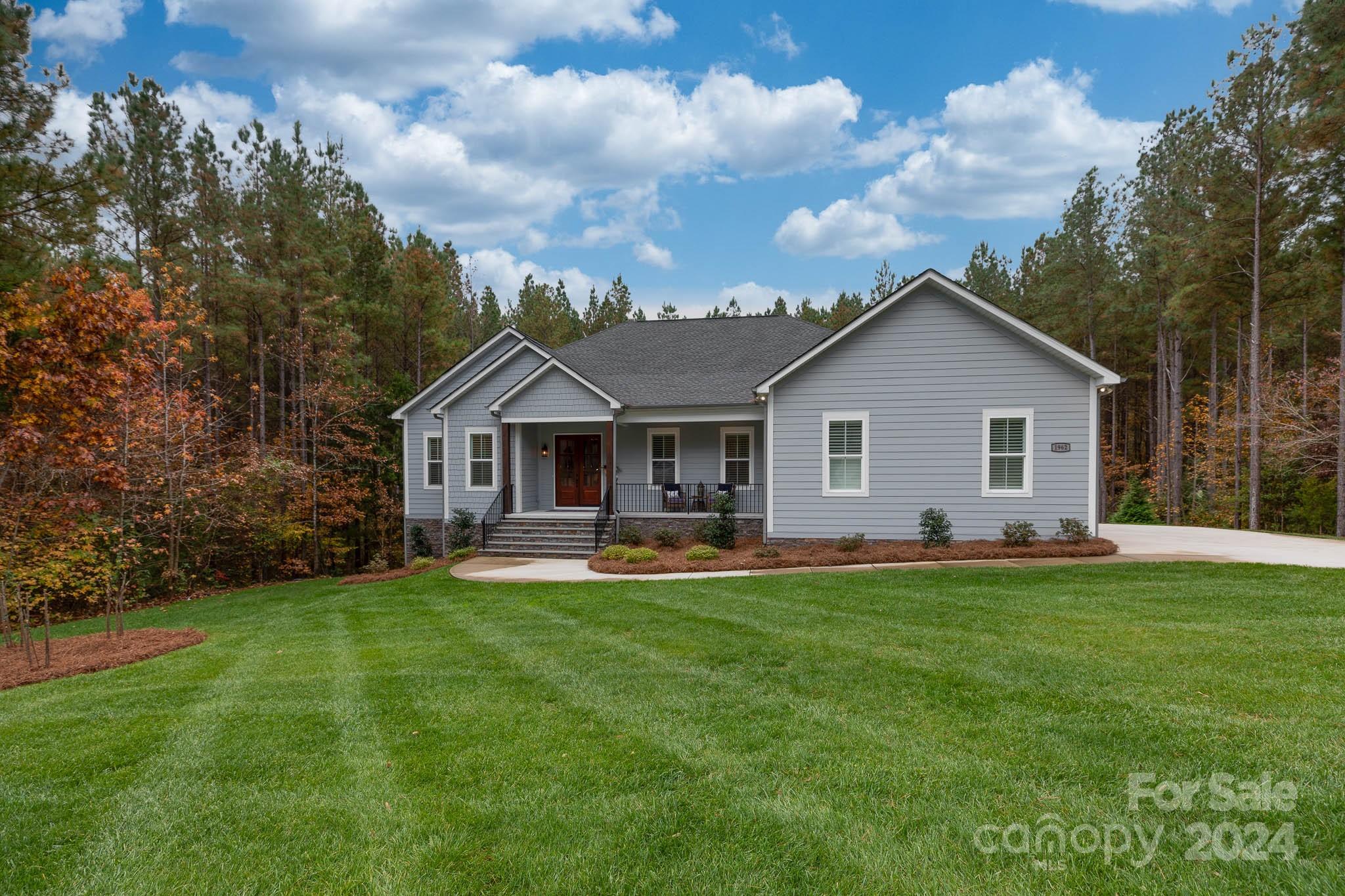Welcome to Catawba Shores Estates, a nature lover’s paradise nestled along the picturesque Catawba River, just 25 minutes from Charlotte. This stunning community offers a pool, paddle sports launch site & walking trails. This charming 4 bedroom, 4.5 bath ranch home with a basement is much larger than it appears. The inviting front porch sets the stage for a beautifully maintained, move-in-ready home. The main level boasts a spacious primary suite with vaulted ceilings, wood beams, marble-tiled shower, freestanding tub & custom walk-in closet. The great room showcases a vaulted ceiling, wood beams & stacked stone fireplace. The kitchen is a chef's dream, featuring a huge work island with quartz countertops, breakfast bar, double ovens & walk-in pantry. The lower level offers a secondary living space with a fireplace, multiple flex spaces, a bedroom & full bath, as well as a substantial unfinished storage area. Enjoy the serene surroundings from screened porches on both levels!