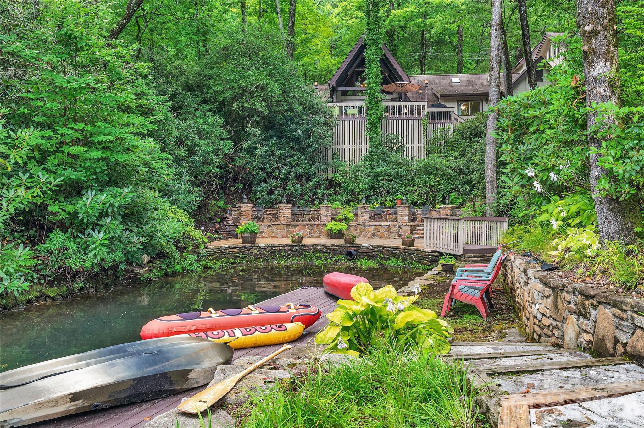 Eclectic and charming 4-bedroom, 6.5-bath lakefront retreat set in a magical private cove overlooking Lake Toxaway. Tucked away in a peaceful setting with its own boathouse and expansive stone patio right at the water’s edge, this spacious home offers serenity, comfort, and convenience within Lake Toxaway Estates.

Inside, the home features hardwood floors, soaring cathedral ceilings, and two full kitchens with separate living areas. Each of the four bedrooms is a private suite, providing comfort and privacy for everyone. Enjoy lake views from the covered porch and multiple decks.

Experience the ultimate mountain-lake lifestyle on Western North Carolina’s largest private lake in this one-of-a-kind waterfront escape.