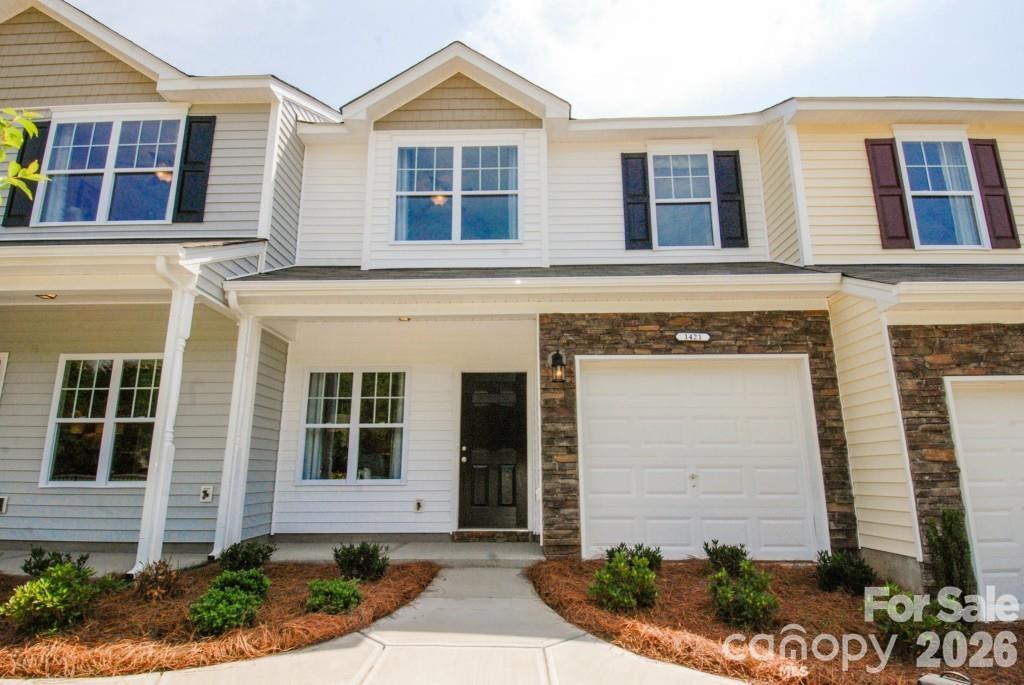Location, Location, Location. Beautiful and well-maintained townhome located in the highly desirable UNC Charlotte area. This home has been freshly painted and features brand new carpet on the stairs and throughout the entire second floor, creating a clean and comfortable living space.

The main level offers an open concept floor plan with a spacious family room that flows seamlessly into the kitchen. The kitchen features stainless steel appliances, plenty of cabinet space, and a cozy breakfast area perfect for everyday meals. All appliances convey with the home, including the refrigerator, washer, and dryer.

Step outside to enjoy a private wooden backyard with a lovely deck, ideal for relaxing or entertaining guests.

The second floor features a versatile loft area that can be used as an office, study area, or additional living space. The large primary suite includes a spacious walk-in closet, while the additional bedroom has easy access to a full bathroom located in the hallway.

Conveniently located with easy access to major highways, UNC Charlotte, the light rail, shopping, restaurants, and entertainment. The community also offers a beautiful family-friendly pool for residents to enjoy.

This home combines comfort, convenience, and an excellent location, making it a wonderful place to call home.