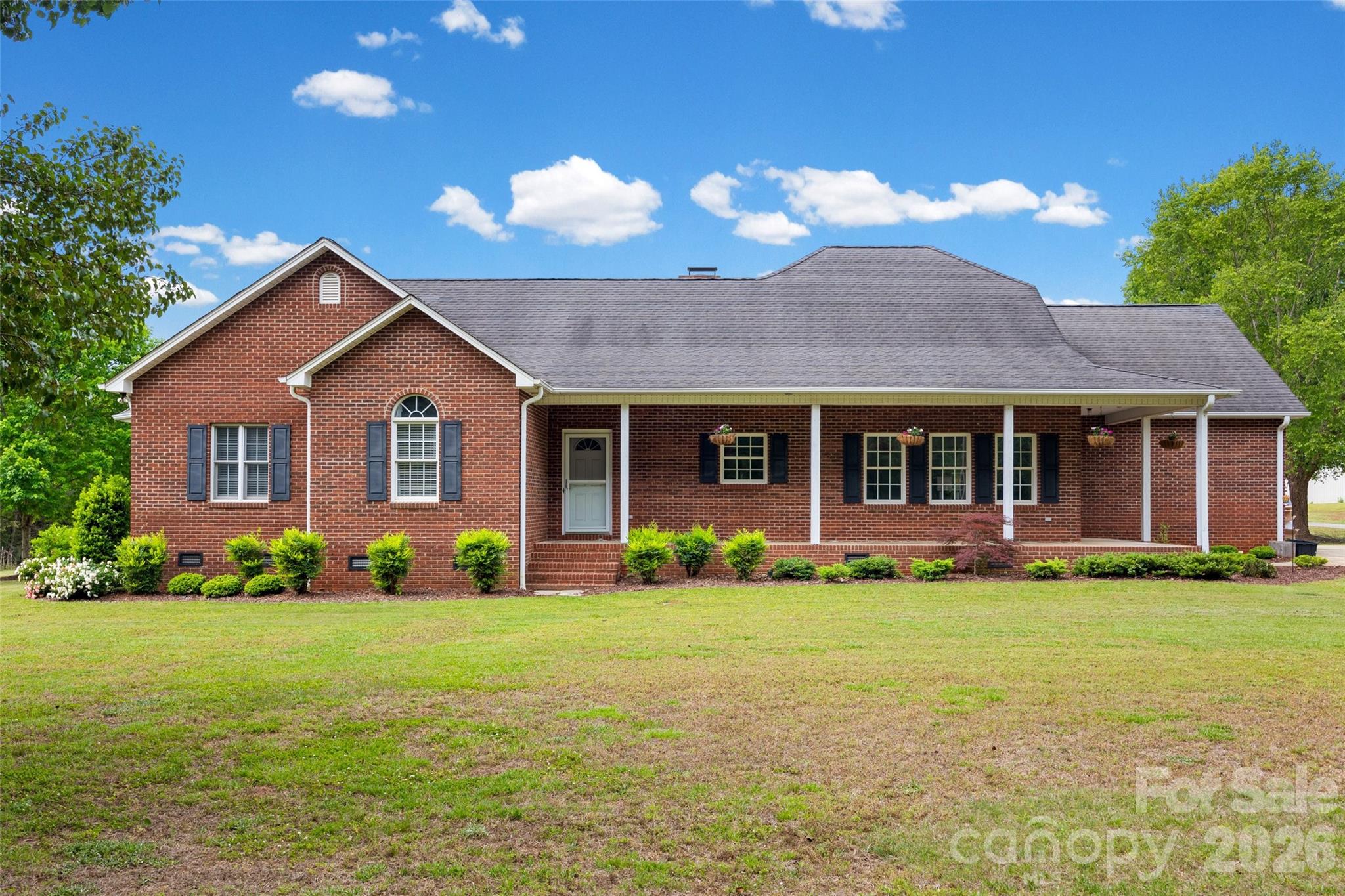 This Charming one-story full Brick home with a spacious Bonus Room over the two-car garage offers the perfect blend of comfort and style- all situated on a generous 1.27 acre lot with no City taxes.  Step inside to find thoughtful updates throughout, including new flooring in Kitchen, dining area, and bonus room, along with fresh paint in most of the home.  The kitchen shines with elegant quartz countertops, a ceramic tile backsplash and SS appliances, complemented by quartz in countertops in the guest bathroom.  The primary suite is a relaxing retreat featuring a tray ceiling, a large walk-in closet, and a well-appointed bathroom with dual vanities, a separate shower, and a garden tub.  The inviting living room boasts hardwood floors, a stunning stone wood-burning fireplace, and soaring cathedral ceilings that create an open, airy feel.  You'll also appreciate the oversized laundry room with abundant storage space.  Enjoy outdoor living at its finest with a classic rocking chair front porch that wraps around one side of the home, a screened-in back porch for year-round enjoyment, and a brand-new paver patio complete with a fire pit- perfect for entertaining or quiet evenings under the stars.  With a level yard and plenty of space to spread out, this property offers both functionality and charm in a beautiful setting.  There is an easement for driveway and Road Maintenance agreement is attached.