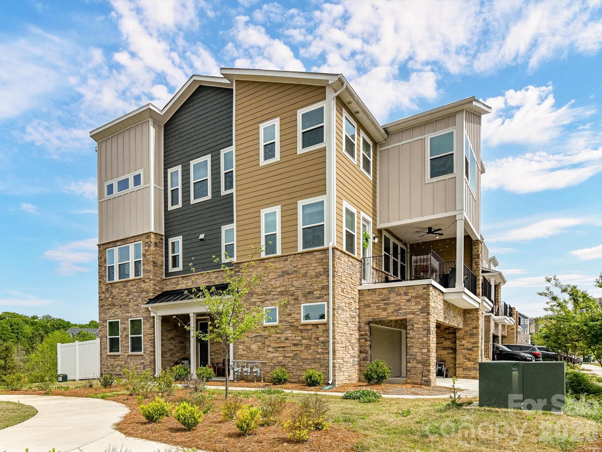 Walkable to University Research Park, TIAA-CREF main campus and Mallard Creek Greenway!  Step into refined comfort with this exceptional and rare end unit 5 bedroom, 4 bath, three-story townhome in the highly sought-after University area. Meticulously maintained and perfectly positioned against a tree-lined backdrop, this residence blends modern sophistication with serene natural surroundings.
Designed with versatility in mind, each level features at least 1 bedroom and full bath —ideal for private guest suites, a stylish home office, a cozy den, or whatever your lifestyle demands. At the heart of the home, a light and bright kitchen exudes modern elegance, featuring a gas cooktop, sleek built-in wall oven, and refined finishes that elevate both everyday living and effortless entertaining. This stunning space flows seamlessly into a light-filled living room, creating an inviting, open-concept setting perfect for gathering, relaxing, and making lasting memories. .

Unwind on the expansive covered balcony, where you can enjoy peaceful views and fresh air after an afternoon at the community pool. A spacious two-car garage with ample storage adds both convenience and practicality to this already impressive home.  Close to Trader Joe's and walkable to Mallard Creek Elementary.

This is more than a home—it’s a private retreat designed for comfort, style, and effortless living. Come experience the lifestyle you deserve.
