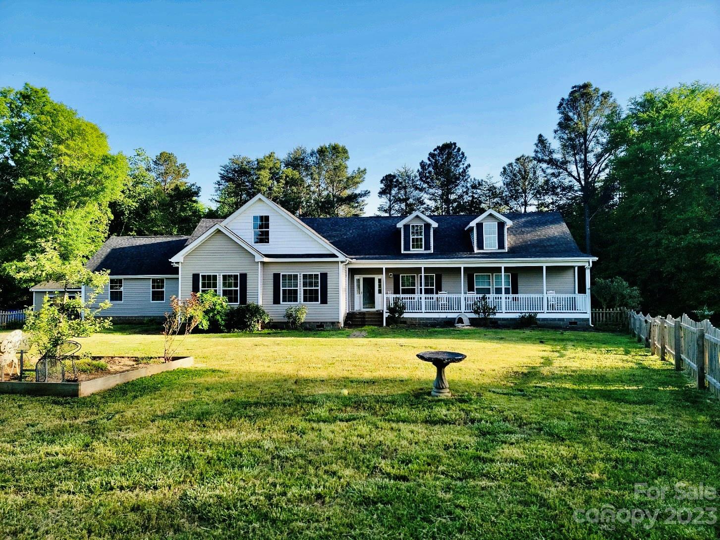 Imagine living on a 4-acre property nestled between Ballantyne and Fort Mill, with paved roads, concrete driveway, and being only minutes from grocery stores and major freeways. Enjoy morning coffee on the front porch or relax on the expansive back deck facing a private backyard full of mature trees. The home features 9-foot ceiling throughout, laundry room with sink, primary bedroom with dual en-suite master bathrooms. The kitchen has plenty of cabinet space for the cook in the family; a full suite of stainless appliances include electric cooktop, range hood, built-in oven, and not to mention the built-in full-size refrigerator and full-size freezer! While living space is on the main floor, the stairway takes you up to an unfinished attic that is just over 1,100 square feet; it's a great space for storage or future bonus room! The lot appears to be sub-dividable per Lancaster County Planning Department, who recommends working with surveyor to determine suitable division location.