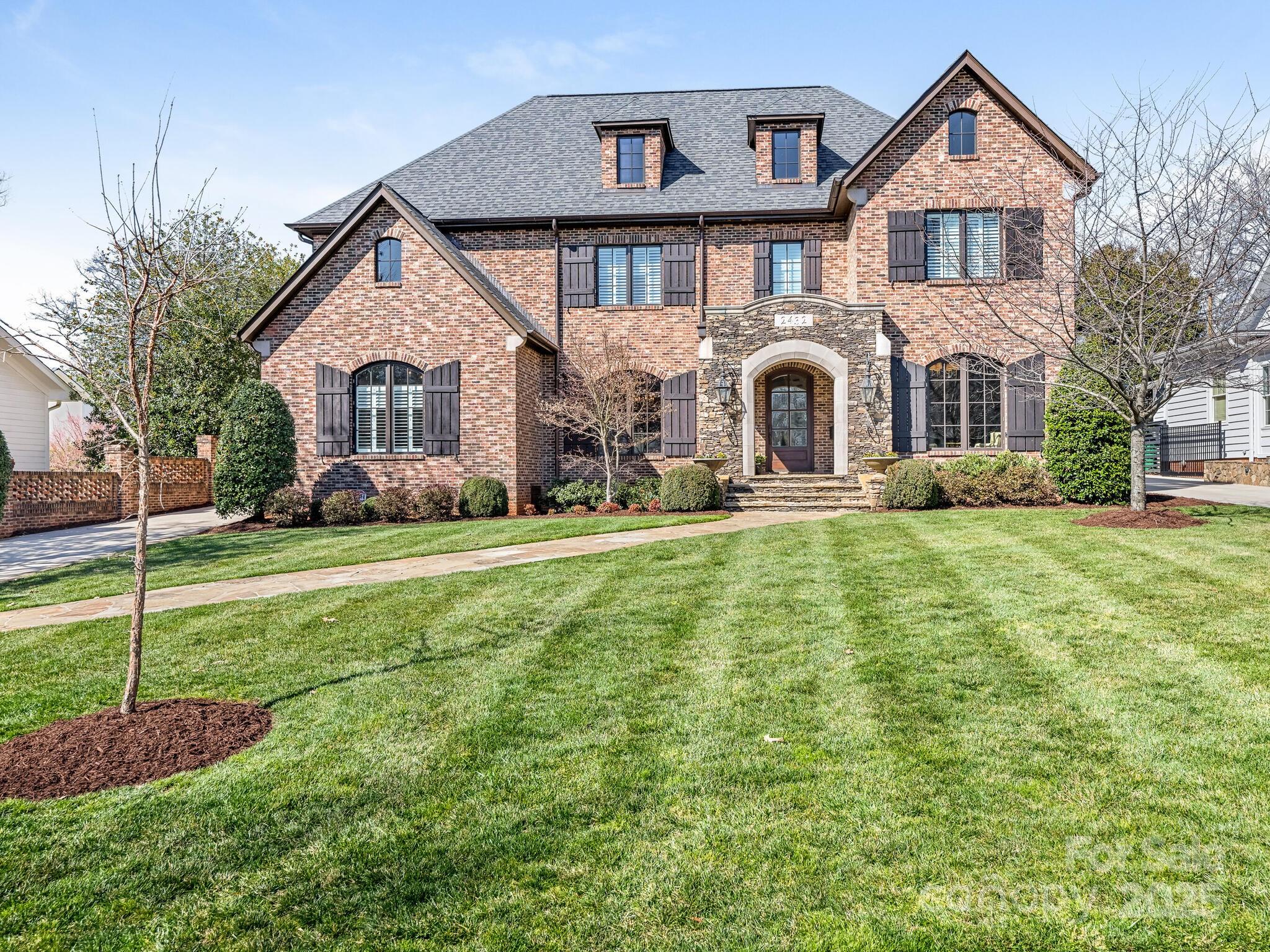 Stunning stone and brick home in the heart of Myers Park. Expansive main level floor plan which is an ideal mix
of spacious rooms, open entertaining areas and private spaces. 
The kitchen boasts a large island, farmhouse sink, double ovens, a walk in  pantry, and  a bright breakfast area. The first level Primary Bedroom Suite has dual walk in closets and and spa like bath. The 2nd bedroom on the main level can serve as an office or guest suite w/ full bath.  Covered outdoor patio is centered by a " see through" fireplace with views of the cloistered rear yard.  The Upper level has 3 additional en suite bedrooms, bonus room and second laundry room. 
Two easily expanded  areas  exist in the main house (above the upper level) and the space above the garage--both have permanent steps in place!