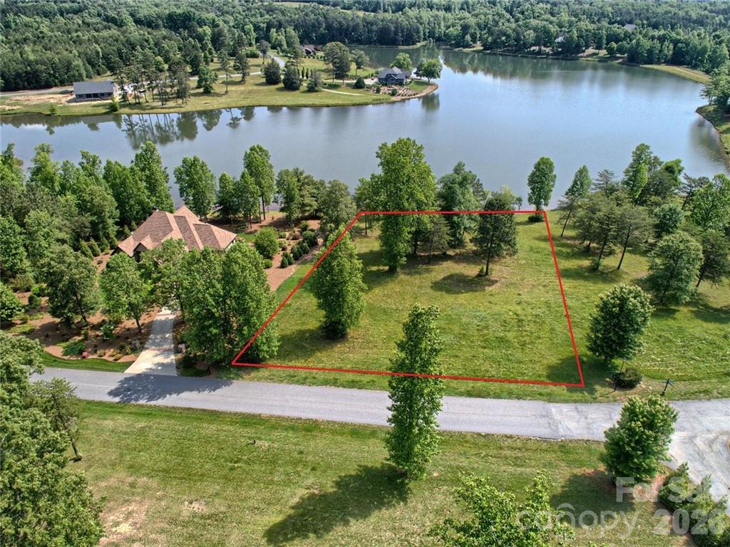 WAIT… WATERFRONT in DERBYSHIRE?! One of the Foothills’ most sought-after gated, equestrian-oriented communities now offers a RARE opportunity to secure what may be one of the LAST PREMIUM LAKEFRONT homesites remaining! 

Why is this lot so special? PREMIUM waterfront homesites within Derbyshire are exceptionally LIMITED, and finding one that offers this combination of topography, view corridors, accessibility, and custom home flexibility is nearly impossible to replicate! Nestled in the beautiful foothills of Tryon/Columbus, North Carolina, this exceptional property combines the DIRECT WATER FRONTAGE, refined country living, and incredible flexibility for creating your dream retreat — all with convenient paved access to I-26, TIEC, Tryon, Landrum, and Columbus.
Whether envisioning a luxury equestrian retreat, peaceful second home, full-time residence, or legacy property for generations to enjoy, this homesite delivers the setting buyers continually search for but rarely find.

Enjoy the DIRECT LAKE FRONTAGE, WHICH IS IDEAL for kayaking, paddleboarding, fishing, sunset strolls, or simply relaxing while overlooking the water from your future porch, terrace, or pool. ***The homesite lends itself beautifully to a primary-on-main design, single-level living, or a walkout lower level with guest suites, entertaining areas, and seamless indoor/outdoor flow directly to the lakefront!!!***

Several CUSTOMIZABLE options available through the builder!!! OR bring your own plans and preferred builder - Explore tailoring one of the existing luxury concepts to fit your vision, lifestyle, and desired finishes. Buyers may have the opportunity to customize selections, layouts, upgrades, specifications, allowance packages, and elevations prior to construction. (*Premium features discussed may include walkout foundations, expansive outdoor living areas, whole-home audio, luxury kitchens, entertaining spaces, and gunite POOL concepts OVERLOOKING the water. Other home styles and concepts are available upon request.)

Derbyshire itself offers a unique blend of equestrian charm and refined mountain-lake living. Community amenities may include riding/warm-up areas, stalls, pastures, quiet roads for walking or riding, and a peaceful atmosphere difficult to recreate in today’s market. Whether your mornings begin with coffee overlooking the water or afternoons spent riding nearby trails and equestrian facilities, the lifestyle here is truly exceptional.

Located only MINUTES from the world-renowned Tryon International Equestrian Center (TIEC), owners enjoy easy access to horse shows, dining, shopping, training facilities, boarding, and year-round events. Plus, you are conveniently positioned near Greenville-Spartanburg (GSP), Asheville (AVL), and Charlotte Douglas International (CLT) airports, making travel and second-home ownership remarkably convenient.

~~~ Don't say I didn't prepare you that this Premium WATERFRONT opportunity within Derbyshire is becoming increasingly rare… don’t miss the chance to create something truly special. Call today for additional information, plans, builder details, or your private tour! ~~~ 
You may also purchase the lot separately and hold as an investment or build later with your preferred builder — see the other additional MLS listing for a LOT-only offering and related details.

(*****MORE PHOTOS AND HOME PLANS/RENDERINGS TO COME SOON)