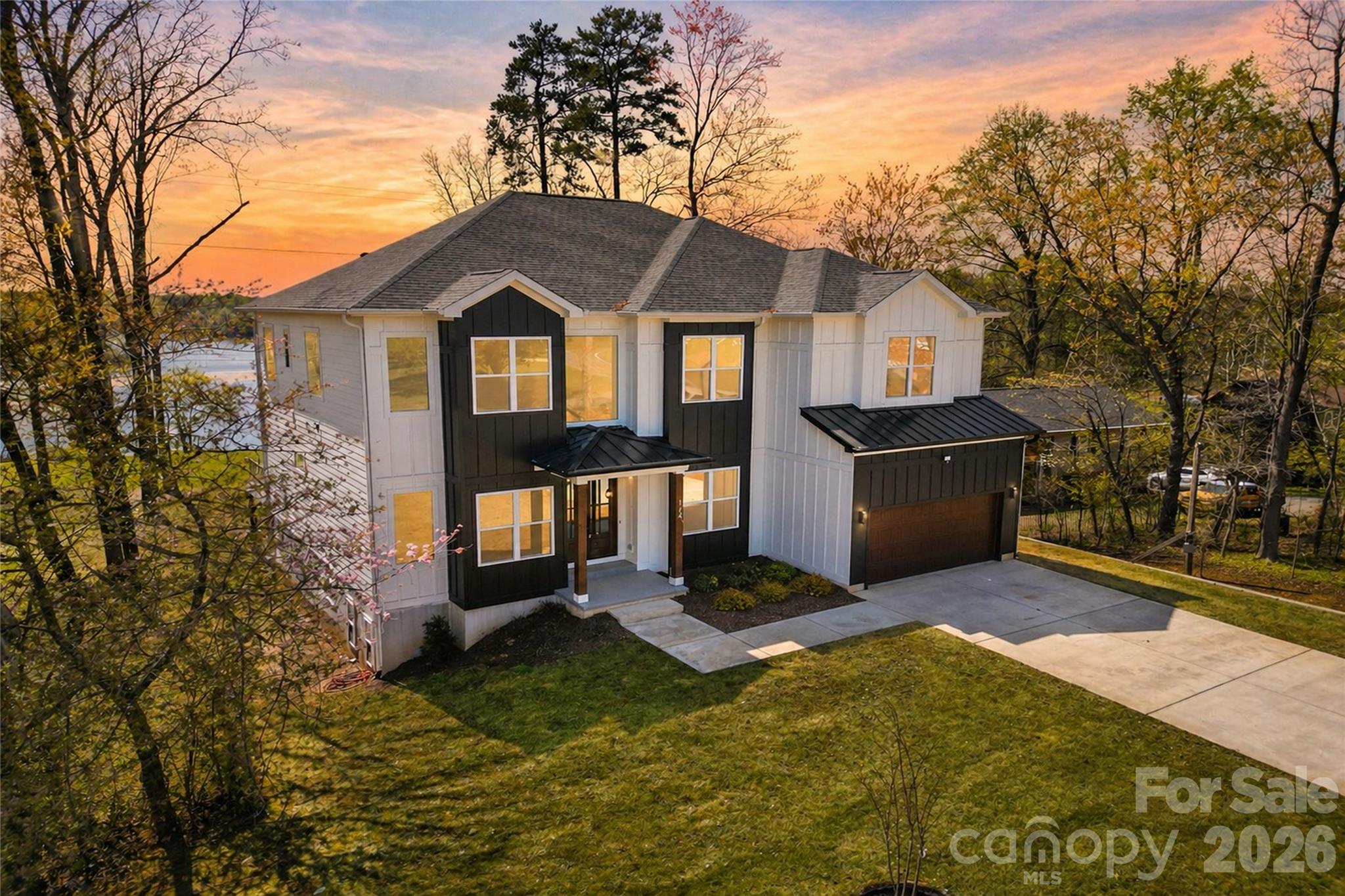 **Waterfront. No HOA. Short-term rental potential.**

Opportunities like this on Lake Norman are increasingly rare.

Set on approximately 1.19 acres with expansive open-water views, this custom-built residence delivers a level of privacy, scale, and flexibility that is difficult to replicate. Whether used as a primary residence, luxury second home, or income-producing asset, the combination of full ownership control, multi-level living, and STR potential creates a compelling advantage in today’s market.

Across all three finished levels, the home offers multiple bonus and flex rooms that can function as additional sleeping areas, guest suites, or private quarters depending on the owner’s needs. While permitted for a three-bedroom septic system, the layout lives far beyond a traditional three-bedroom home, making it especially well-suited for multi-generational living or buyers seeking additional usable space.

The main level is designed to impress immediately, with soaring 12-foot ceilings and a light-filled layout that draws the lake into view from the moment you enter. At the center of the home, an ultra-luxury chef’s kitchen anchors the space, featuring a dual waterfall quartz island, full quartz backsplash, custom cabinetry, and high-end appliances. The kitchen flows seamlessly into the great room, where a gas fireplace and expansive glass doors open to an oversized deck overlooking the water — an ideal setting for elevated entertaining.

A main-level guest suite with en-suite bath, along with a private office or flex space and powder room, provides both functionality and versatility without compromising design continuity.

Upstairs, the primary suite is positioned as a private retreat, offering a spa-inspired bath with dual vanities, a freestanding soaking tub framed by a dramatic floor-to-ceiling window, and an expansive glass-enclosed shower with dual rain heads. Additional bonus and flex spaces allow for customized use, while a pre-designed, soundproofed media or theater room delivers a dedicated entertainment experience rarely found in waterfront homes.

The fully finished walk-out lower level significantly expands the home’s livability and income potential. A second full kitchen, additional living areas, laundry, and multiple flex rooms create an ideal configuration for multi-generational living, extended guest accommodations, or private quarters, enhancing both lifestyle and rental flexibility.

Outside, the property becomes the experience. The private pier and covered floating dock offer direct access to Lake Norman, creating a seamless transition from home to water. The expansive lot provides both privacy and usable space, with the opportunity to further elevate the outdoor environment — including potential for a pool with septic reconfiguration.

The home is currently permitted for a three-bedroom septic system and includes multiple additional bonus and flex rooms across both upper and lower levels, allowing owners to tailor the layout to their needs while also creating a path for future value enhancement.

With its combination of waterfront presence, scale, and rare no HOA flexibility, this property stands apart as a high-control, high-potential Lake Norman offering designed for both luxury living and long-term upside.