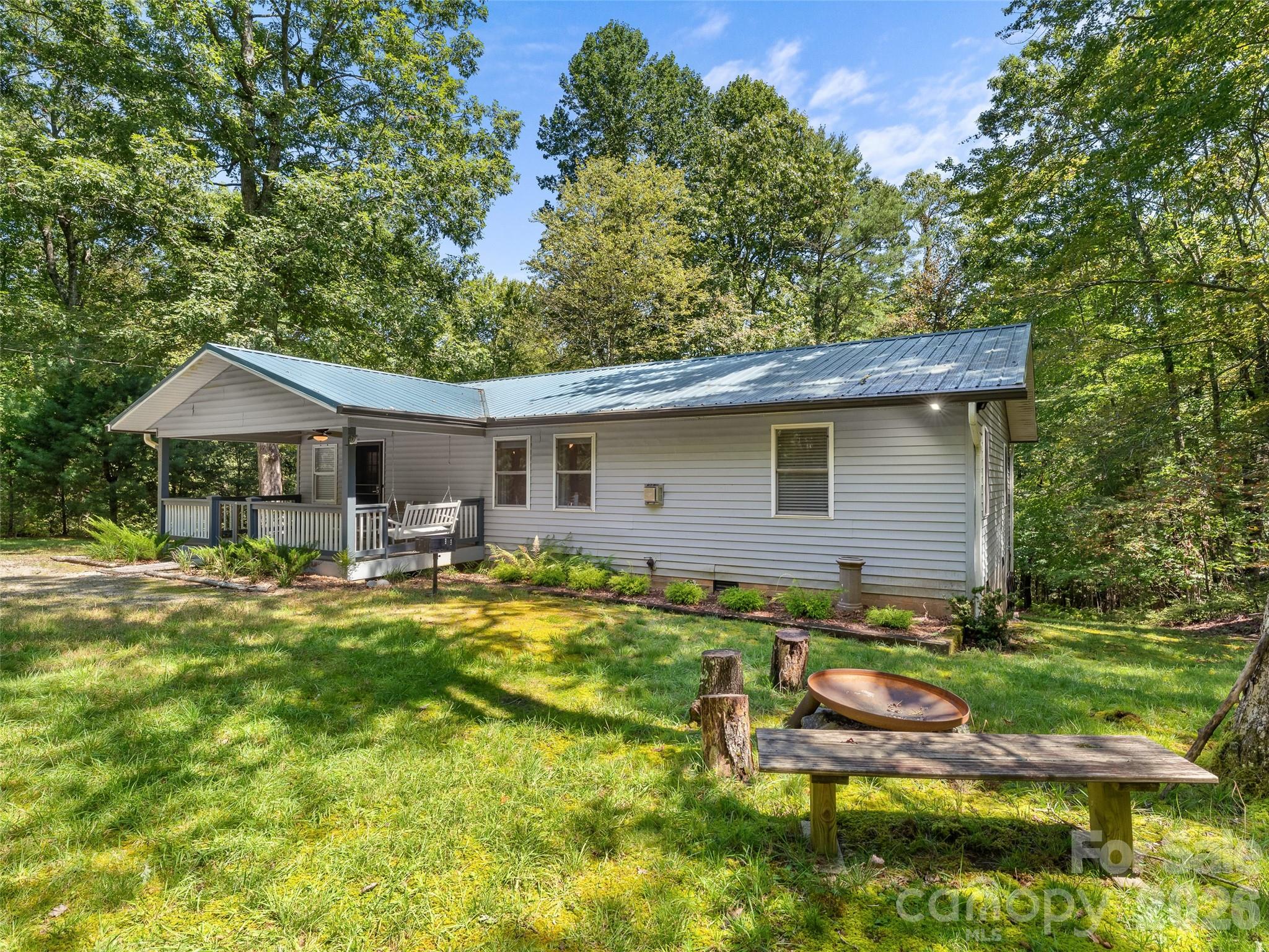 Tucked away in the heart of the Appalachian forest, this private mountain retreat offers the perfect blend of serenity, adventure, and modern comfort. Surrounded by expansive public lands, you can walk or bike directly to trailheads leading into Headwaters State Forest, with Caesars Head State Park and the breathtaking Mountain Bridge Wilderness Area just minutes away. Whether you crave peaceful mornings on the porch or full days exploring waterfalls and scenic overlooks, this location delivers an unmatched outdoor lifestyle.

Inside, thoughtful renovations elevate the home with fresh style and functionality. The updated kitchen features new cabinetry, beautiful countertops, a generous island perfect for gathering, and a professional-grade gas range with hood — ideal for entertaining or crafting a quiet meal after a day on the trails. Durable LVP flooring, a newer HVAC system, and a cozy gas-fired parlor stove provide comfort and efficiency year-round.

Privately positioned near the end of a quiet gravel road, this property offers rare seclusion while remaining accessible. Equally suited as a full-time residence, weekend escape, or income-producing vacation rental, this mountain hideaway is ready to welcome its next chapter.

Buyer’s agent must be licensed in South Carolina.
