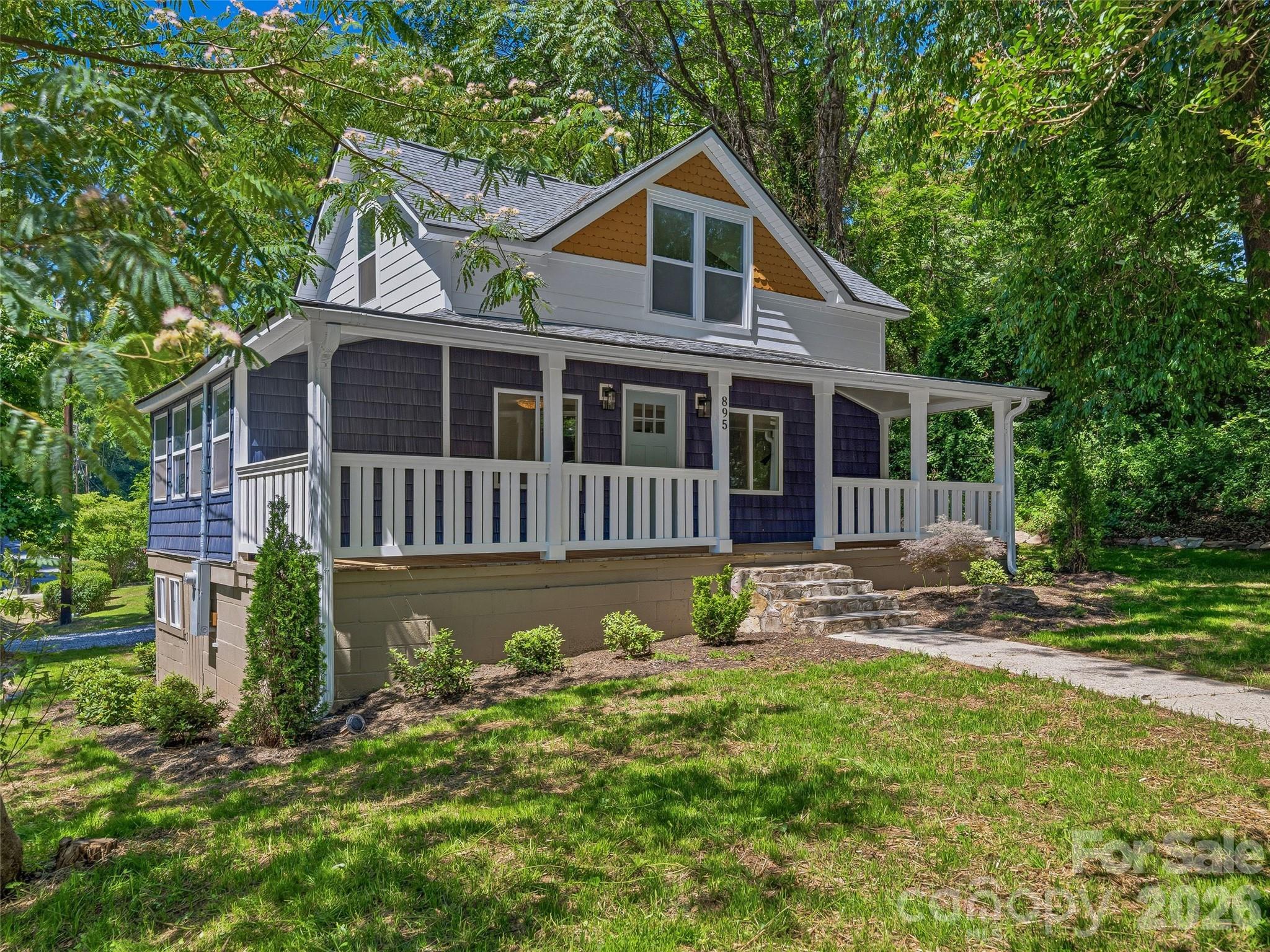 Beautifully renovated 1920 cottage just a few blocks from the shopping, dining, and charm of downtown Tryon. Offering with 3 bedrooms and 3 full baths, this inviting home blends the character of a historic property with the conveniences and reliability of a new home. Extensive updates include a new roof, siding, windows, flooring, lighting, insulation, dual-zone HVAC, plumbing, electrical, and water heater. The welcoming covered front porch opens to bright interiors with wide-plank flooring, crisp finishes, and a charming stone fireplace. The stylish kitchen features new cabinetry, GE appliances, brass hardware, tile backsplash, and a fresh modern design. Updated baths include new fixtures, vanities, tile, and shower surrounds. Flexible living spaces provide options for guests, work-from-home needs, or quiet retreat. Set on 0.31 acres with mature trees, stone steps, fresh landscaping, and gravel parking, this thoughtfully renovated home offers wonderful potential as a primary residence, second home, or investment property.