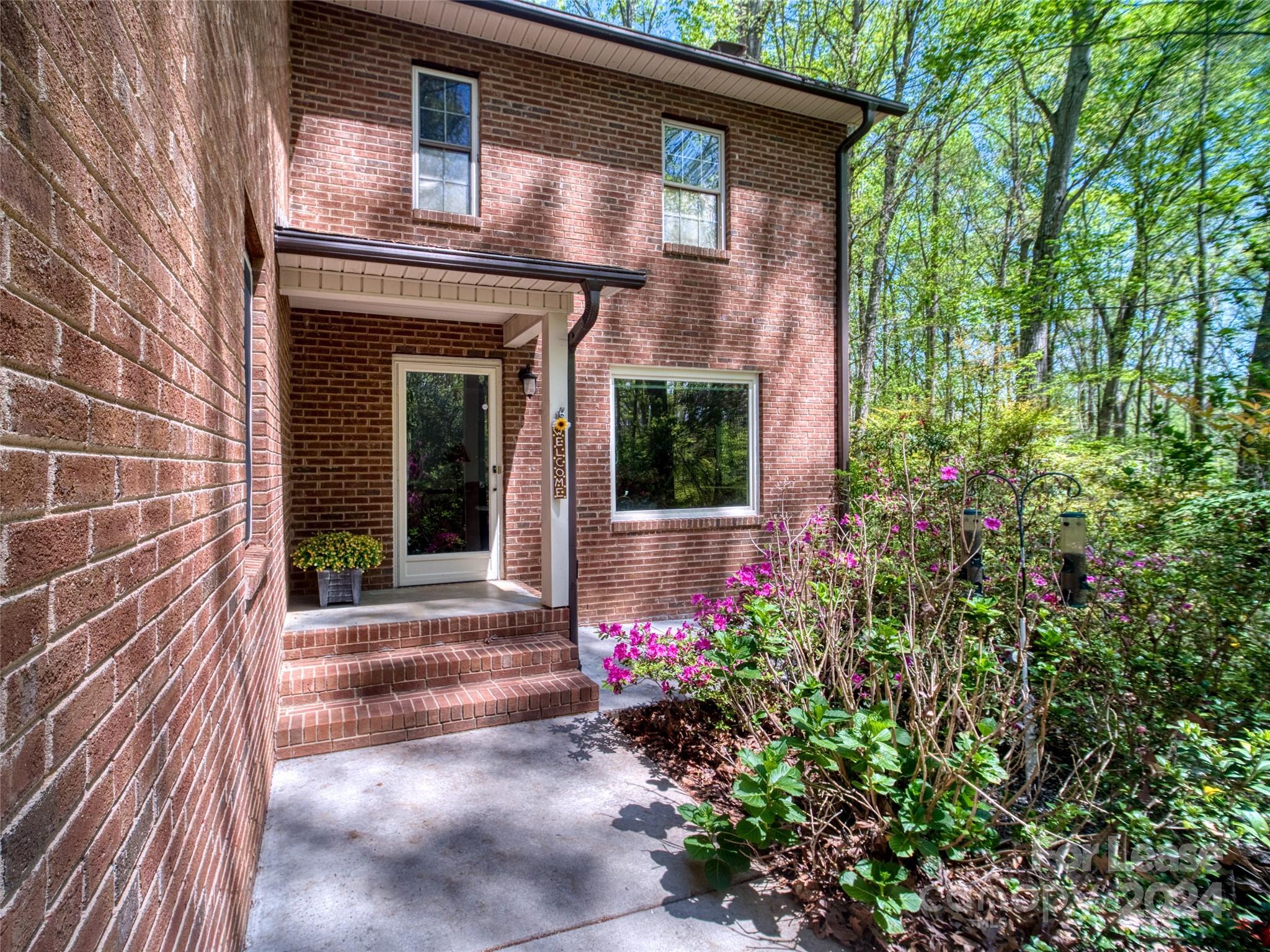 Experience complete privacy and tranquility in this custom-built, all-brick home set on nearly 5 secluded acres. This beautiful, move-in ready home boasts a master suite on the main level and three spacious bedrooms upstairs, each with large closets. Additionally, there is a substantial cedar-lined closet off the hall and a walk-in attic. The lower level is a fully equipped self-contained apartment, complete with a washer and dryer. The basement also includes a storage/utility room with a wood-burning heater. The exterior features all-brick construction and gutter guard gutters, which come with a lifetime transferable warranty.