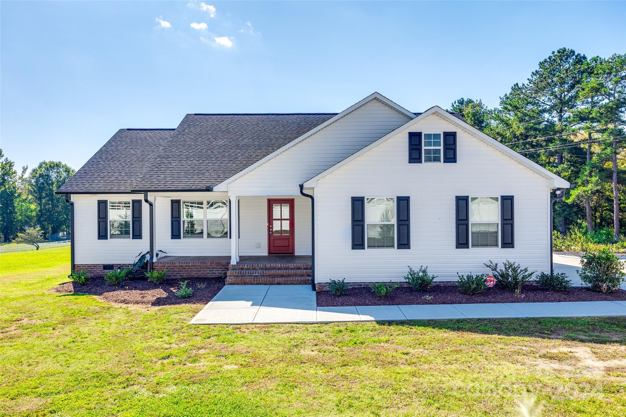 Almost new with tons of upgrades you won’t find in a new house!   Owners added a screened porch, a retractable awning on the deck, landscaping with a drip system, fencing and solar panels. The inviting crisp, white exterior and rocking chair front porch welcome you to a fabulous floor plan with an open kitchen/living room perfect for entertaining and relaxing. Bright white kitchen with large island and granite counters as well as trey ceilings, crown molding and wide-plank LVP flooring too! Split bedroom plan with 2 additional bedrooms and bath. Oversized laundry/mudroom provides extra storage. This beautiful home combines modern design with a peaceful, country setting. What are you waiting for? Come discover it today!
