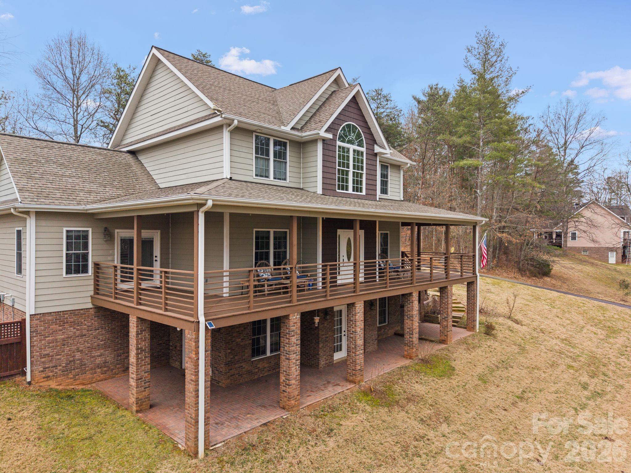 Tucked on a private, wooded acre just minutes from downtown Weaverville and Asheville, this immaculately maintained 4 bedroom, 4 bath home blends peaceful living with everyday convenience. A welcoming wraparound porch leads into a light-filled layout featuring hardwood floors, a private office, formal dining room, and an eat-in kitchen open to the living area. The spacious main-level primary suite offers a quiet retreat, while three large upstairs bedrooms provide flexible space for guests or work-from-home needs. The mostly finished basement adds a family room, bonus bedroom, full bath, exercise studio, and abundant storage. Enjoy year-round relaxation in the climate-controlled sunroom and enclosed patio with wood-burning fireplace or step outside to relax in the hot tub. Close to parks, schools, shopping, and only 5 minutes from Downtown Weaverville and 15 from Downtown Asheville