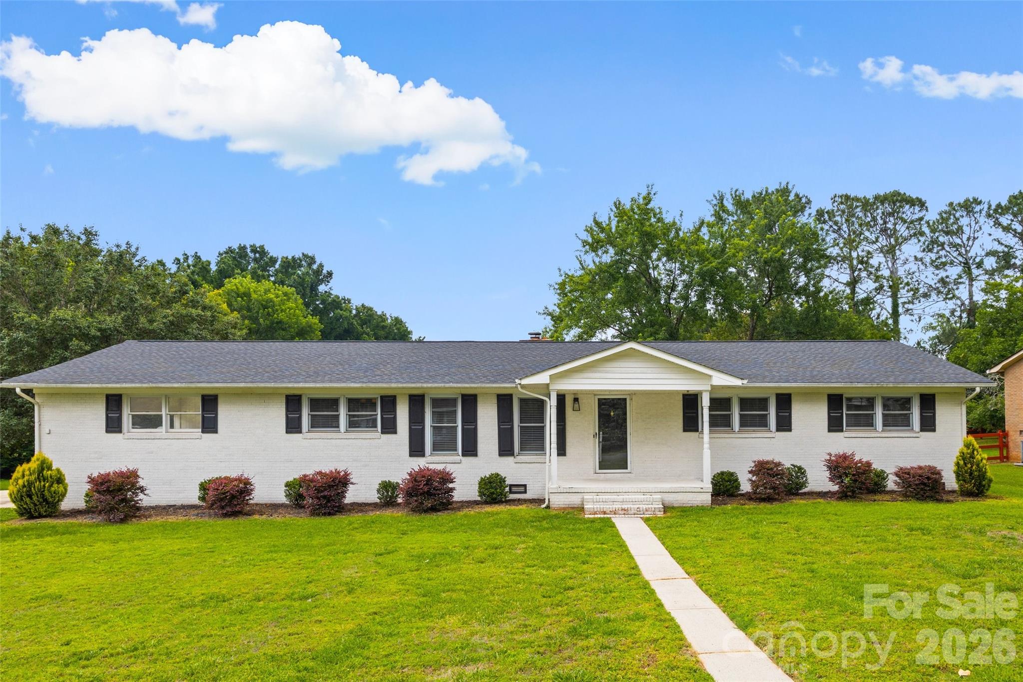 Step into this bright and spacious brick ranch offering nearly 2,000 sq ft of comfortable living on a generous 0.54-acre lot in the heart of Rock Hill. Sunlight pours in through skylights and expansive windows, highlighting the open living space that flows effortlessly into a large, inviting sunroom perfect for relaxing, entertaining, or enjoying year-round views overlooking the backyard. Durable hard surface flooring runs throughout, adding style and easy maintenance to every room. Outside, the possibilities are endless with a wide-open yard ideal for gardening, play, or gatherings, plus two oversized storage sheds with garage doors for all your tools, toys, and hobbies. Tucked in a prime location close to shopping, dining, schools, parks, and I-77, this home delivers the perfect blend of space, convenience, and everyday wow-factor.