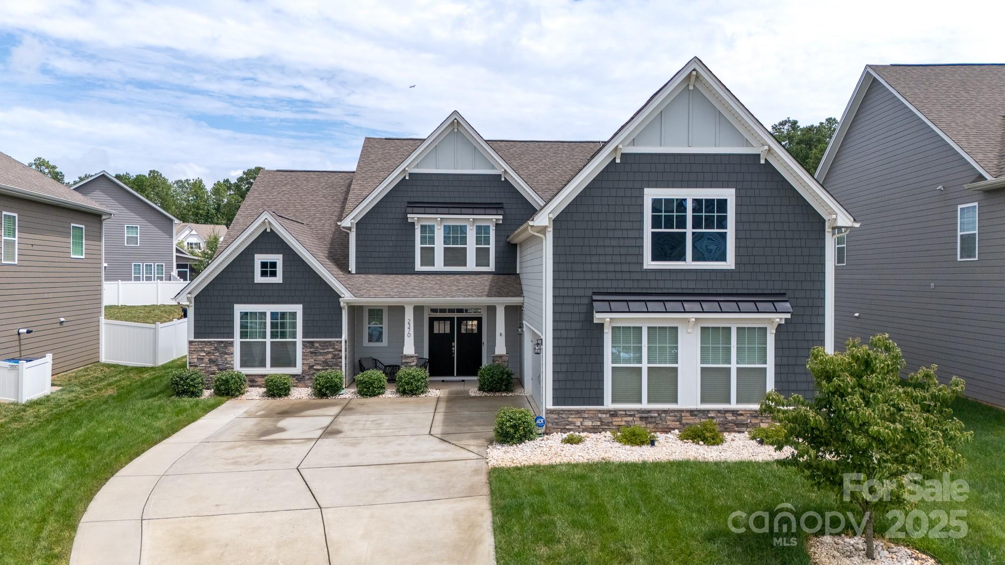 Located in the desirable Cypress Point subdivision in Lake Wylie, this stunning 5-bedroom, 4.5-bath home offers a spacious and functional layout with high-end finishes throughout. The main level features a luxurious primary suite with dual vanities, a tiled shower, and a walk-in closet, plus a secondary bedroom with a private ensuite—perfect for guests or multi-generational living. The open-concept main living area boasts a chef’s kitchen with quartz countertops, gas cooktop, double wall ovens, and a walk-in pantry. Upstairs, a generous bonus room offers flexible living space. Step outside to a private backyard retreat complete with a covered rear porch, paver patio, firepit, and a resort-style pool with integrated spa. Additional highlights include an oversized side-load 2-car garage, drop zone, and both front and rear porches. Cypress Point amenities include a clubhouse, pool, fitness center, game court, picnic area, and playground. This one checks all the boxes!