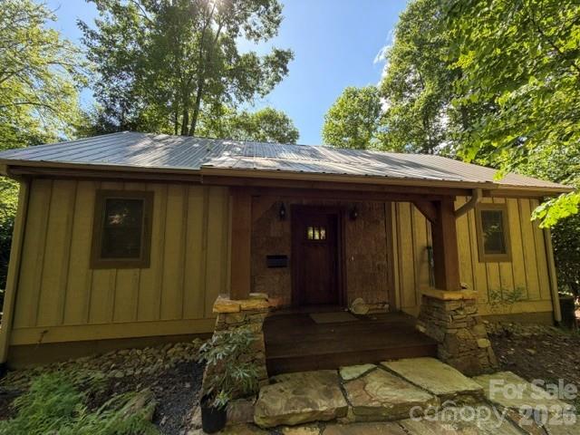 Well-Maintained Cabin in the Woods! Nestled on approximately 0.9 acres (to be surveyed from a larger tract), this charming 3-bedroom, 3.5-bath mountain home offers the perfect blend of comfort, character, and opportunity. Recent improvements include fresh interior paint and a new furnace, providing added value and peace of mind.

The inviting open-concept living area features a vaulted tongue-and-groove ceiling and a stunning floor-to-ceiling stone-stacked wood-burning fireplace, creating a warm and welcoming atmosphere. The main level is designed for convenient everyday living, offering a spacious primary suite with an oversized soaking tub, walk-in closet with built-ins, and easy access to the kitchen, dining, and living areas.

The lower level expands the living space with a cozy den featuring a double-sided fireplace that opens to the covered deck, a full bath, laundry room, generous second primary suite with en-suite bath, third bedroom, and additional storage.

Whether you're seeking a full-time residence, mountain retreat, or investment property, this home offers exceptional versatility and potential. The property has been tenant-occupied for the past two years, and the seller makes no representations on the Residential Property Disclosure, as the owner has never occupied the home. Tax value to be determined upon completion and recording of the survey.

All residents of Mountain Air enjoy 24/7 gated security, six miles of hiking trails, seven parks, and private runway—along with quick access to Asheville, approximately 35 minutes away via four-lane roads. Our community is known for its mountaintop golf, panoramic Blue Ridge vistas, and the highest elevation runway east of the Mississippi!  Mountain Air Country Club amenities offer an 18-hole golf course, state-of-the-art gym, Spa, club dining, Mountain Market, Pro Shop, tennis, pickle ball, and a calendar of activities! Amenities available with club membership; see attachments for additional information.
