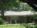 Country Living only 6 miles from Interstate 77 for easy commute to Charlotte NC.  Stocked Pond on 11.65 Acres with shady oaks and sunny areas of grass.  3 Bedroom 1.5 Bath Brick Home with full walk-out basement and sunroom/patio.  Large workshop with office and 1 car parking.  Grapevines, blueberry bushes, figs, daylilies and much more.  Small fenced area for pets, and plenty of land for walking and as pasture for horses.