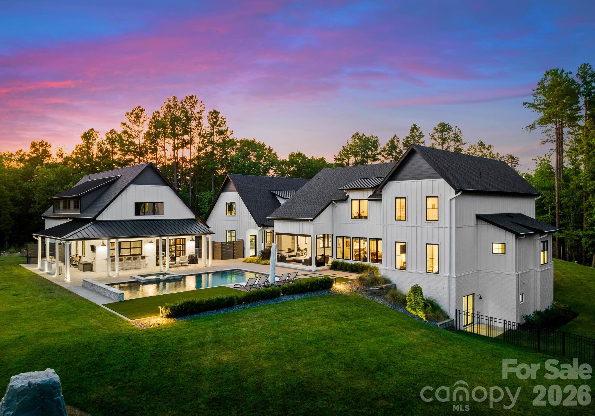 Masterfully Crafted 7,934 SF Home on 10.9 Waterfront Acres with Entertainers Backyard creating a Private Lake Norman Retreat with Covered Dock. Designed, Built, & Lived-in by Seller with Long Legacy in Construction Industry. This stunning home features spacious bedrooms & 2 Bonus Rooms. The Gourmet Kitchen, with its Top-of-the-Line Appliances, Elegant Lighting, & Scullery, is a Chef's dream. Primary Suite featuring Custom California Closets & a Lavish Bathroom w/Heated Floors, a Freestanding Soaking Tub, & an advanced Push-Button shower system. Seamless Indoor-Outdoor living with a Retractable Screen Porch overlooking a sparkling Swimming Pool. The adjacent Pool House features Garage-style Doors that open to the Pool Deck, a Full Gar, & a Golf Simulator Screen. A 5-Car Garage with Epoxy Floors & Climate Control, plus 2,124 SF of Unfinished Space for future customization. Professionally landscaped grounds with Irrigation & Smart home Technology enhance this property.