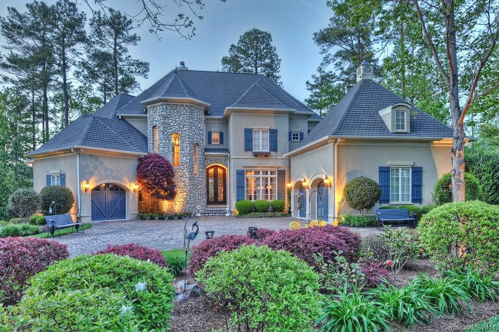 Spectacular lake front estate located in the Village section of the Point, home of Trump National Golf Club. This home was renovated in 2009. New gourmet kitchen w/ 3 refrigerators, 3 microwaves & 3 dishwashers. New bathrooms, gorgeous home! Lower level boasts a 2nd kitchen, 4th car garage, fabulous porch area w/remote screens. Your backyard oasis awaits with outdoor living to enjoy year round! Private pier,dock, sand beach w/180+ feet of block seawall. Truly a showcase home!
