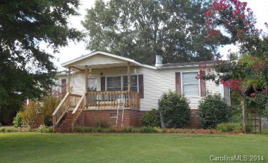 High Rock Lake Community...Cute double wide on great 1 ac. lot with double detached garage, triple detached carport with boat/RV storage space. Gas log fireplace in living room, laminate and vinyl flooring, 3 bedrooms, 2 full baths, large laudry room. Central heat and air, private well and septic. Roof is just 5 years old! Boat ramp fee just $25.00 per year! YOU CAN AFFORD TO LIVE AT THE LAKE!