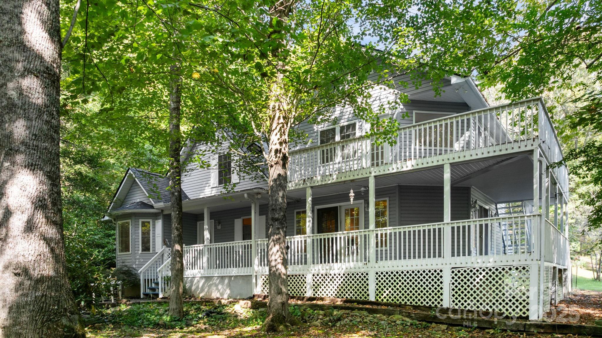 Great opportunity in the Burningtown area! This spacious 3BR/3BA home sits on 4.88 unrestricted, usable acres featuring approximately 477’ of stocked trout stream frontage (not in a flood plain). The flexible floor plan offers a bonus room, office, formal dining, and two living areas, providing ample space for work and play. While the bones seem solid, it is ready for your creative cosmetic updates to truly make it shine. Recent updates include a new roof in 2023, zoned HVAC units replaced in 2018, and a whole-house generator for peace of mind. Both the interior and the expansive wrap-around decks were freshly painted in August 2025. Enjoy a peaceful, tree-lined drive with paved access right to your door. The property features a carport, storage buildings, and a cleared area at the entrance—perfect for a future shop, barn, or second home. Located just 10 miles from downtown Franklin, this property offers a combination of private creek-side living, functional land, and easy accessibility.