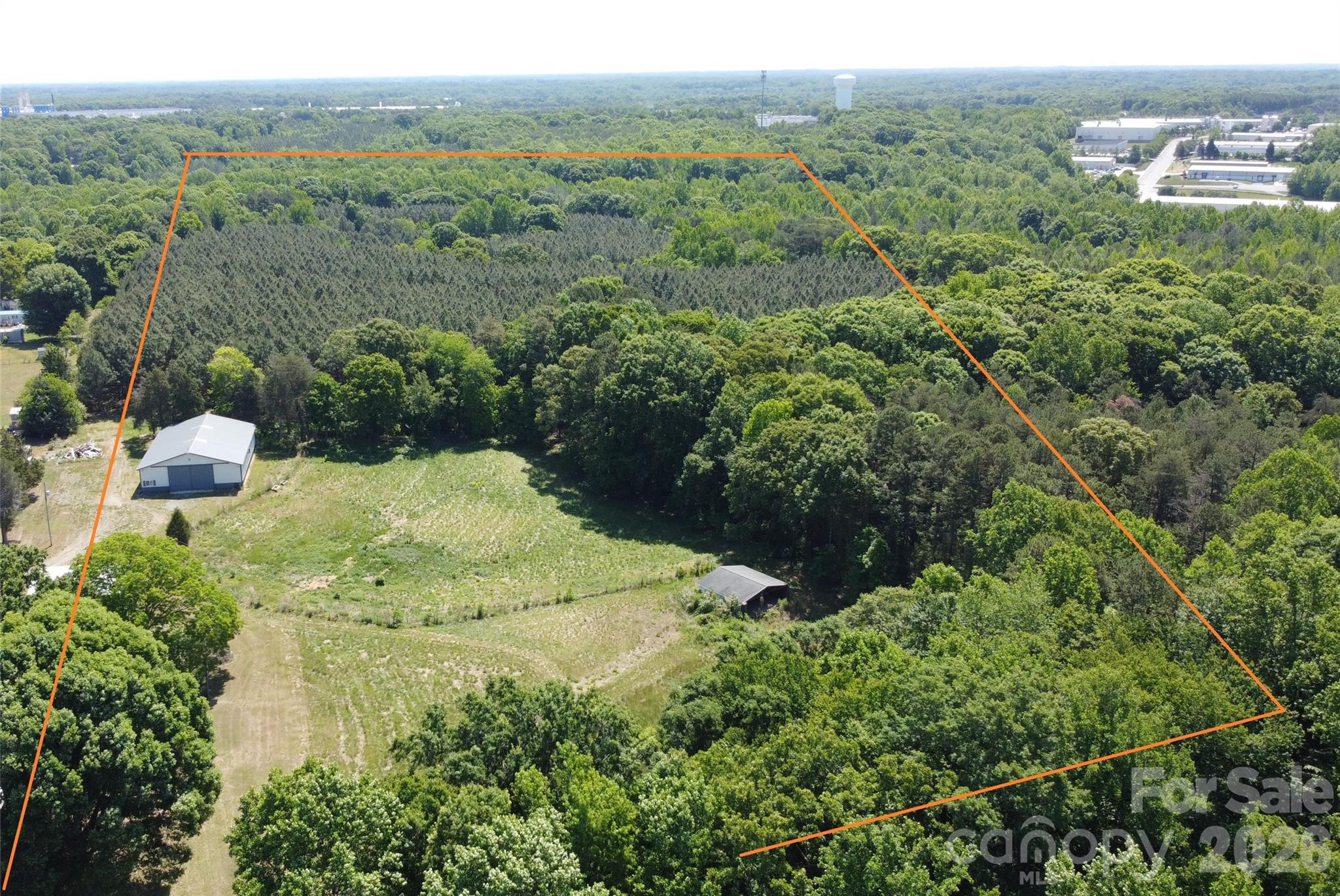 41 +/- acres - excellent potential for a development, including the possibility of a housing subdivision. There is a house and approx. 60x80 workshop on the property that has septic and well, with an additional septic and well already in place.