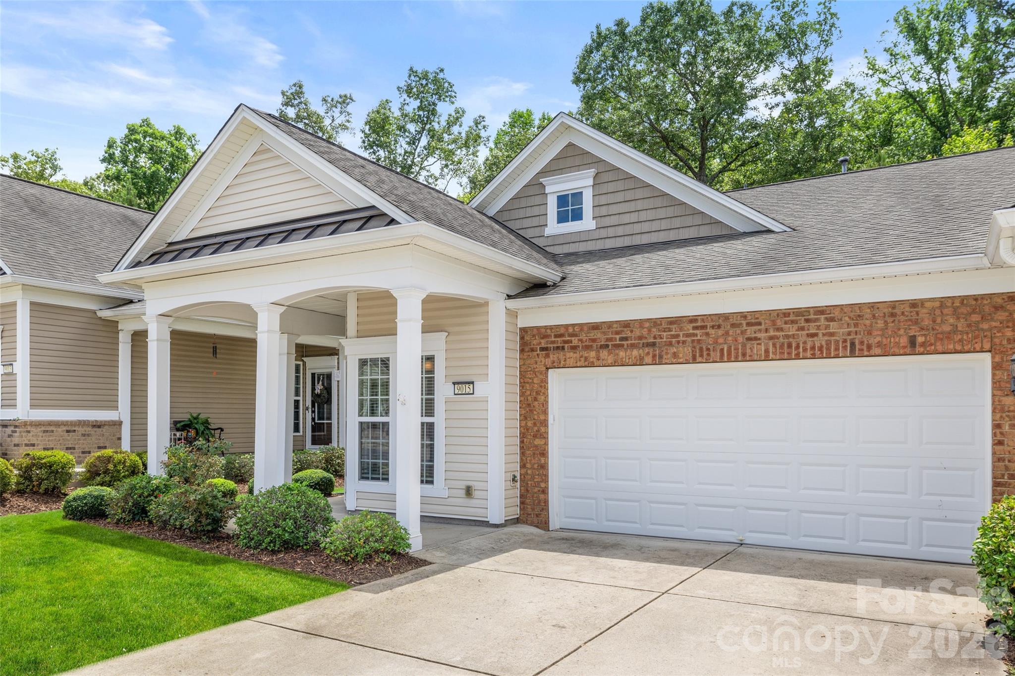 Welcome to low-maintenance, resort-style living in this beautiful end-unit "Kenwood" model townhome nestled in the premier 55+ active-adult community of Sun City Carolina Lakes. This one-level villa features a highly desirable open floor plan highlighted by extra natural light from its end position and a signature front kitchen complete with a sunny bay-window breakfast nook. The bright interior is enhanced by an elegant mix of hardwood and tile flooring throughout the main living areas, which flow seamlessly into a spacious dining and great room area. The private owner's suite serves as a relaxing retreat, boasting a generous walk-in closet and an ensuite bath with dual sinks. A secondary bedroom and full bathroom are thoughtfully placed at the opposite end of the home for optimal guest privacy. Complete with an attached garage and a peaceful backyard space, this property includes HOA-provided lawn maintenance, leaving you all the free time you need to enjoy the community's championship golf course, swimming pools, tennis courts, and bustling Lake House clubhouses.