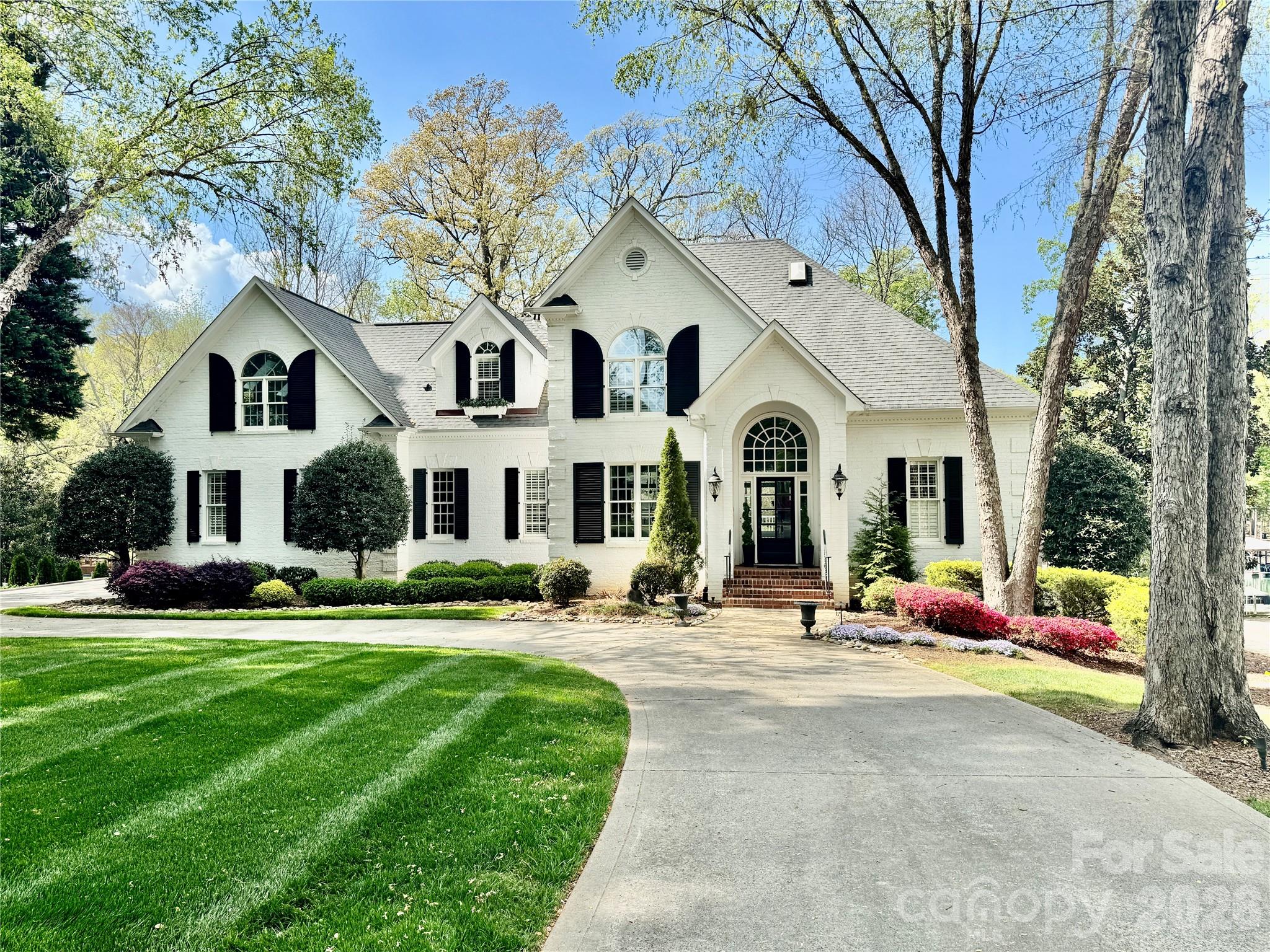 Lovely and refined all brick waterfront home in the popular tree lined Patrick's Purchase neighborhood. Home is set on a .93 acre beautifully landscaped impervious exempt lot.  As you walk thru the open main level you will see an expanse of lake facing windows, a 2 story formal living room, the beautifully updated kitchen and the large but warm family room space. Custom millwork and doors are evident throughout the home. The elegant primary suite is also on this level. This lake facing bedroom opens onto the deck to enjoy your coffee overlooking the glorious azalea lined backyard. There are marble countertops as well as a Japanese soaking tub in the primary bath. Last but not least is the incredibly spacious walk in closet which includes a pull down ladder up to another full closet space above. Upstairs boasts two bedrooms, two baths, a washer/dryer closet and two large flex spaces. Either of these flex spaces could be converted to a third upstairs bedroom and bath. The finished walkout basement has a large family room, a guest bedroom with en-suite bath, an office that could also become a bedroom if you choose and an exercise room with Sauna. There is also another full bath on this lake level. This home has tons of storage. The basement has a large storge room with a large walk-in safe.  There also is a cedar closet under the home. The home was converted to a Smart Home in 2024. The circular drive has additional parking on the side. The two boats lifts convey with the home. If you picture a pool in your backyard this property has plenty of room to add a beautiful pool, a pool house, a firepit or whatever would make this your dream home!  Don't miss your opportunity to be on the lake by summer!