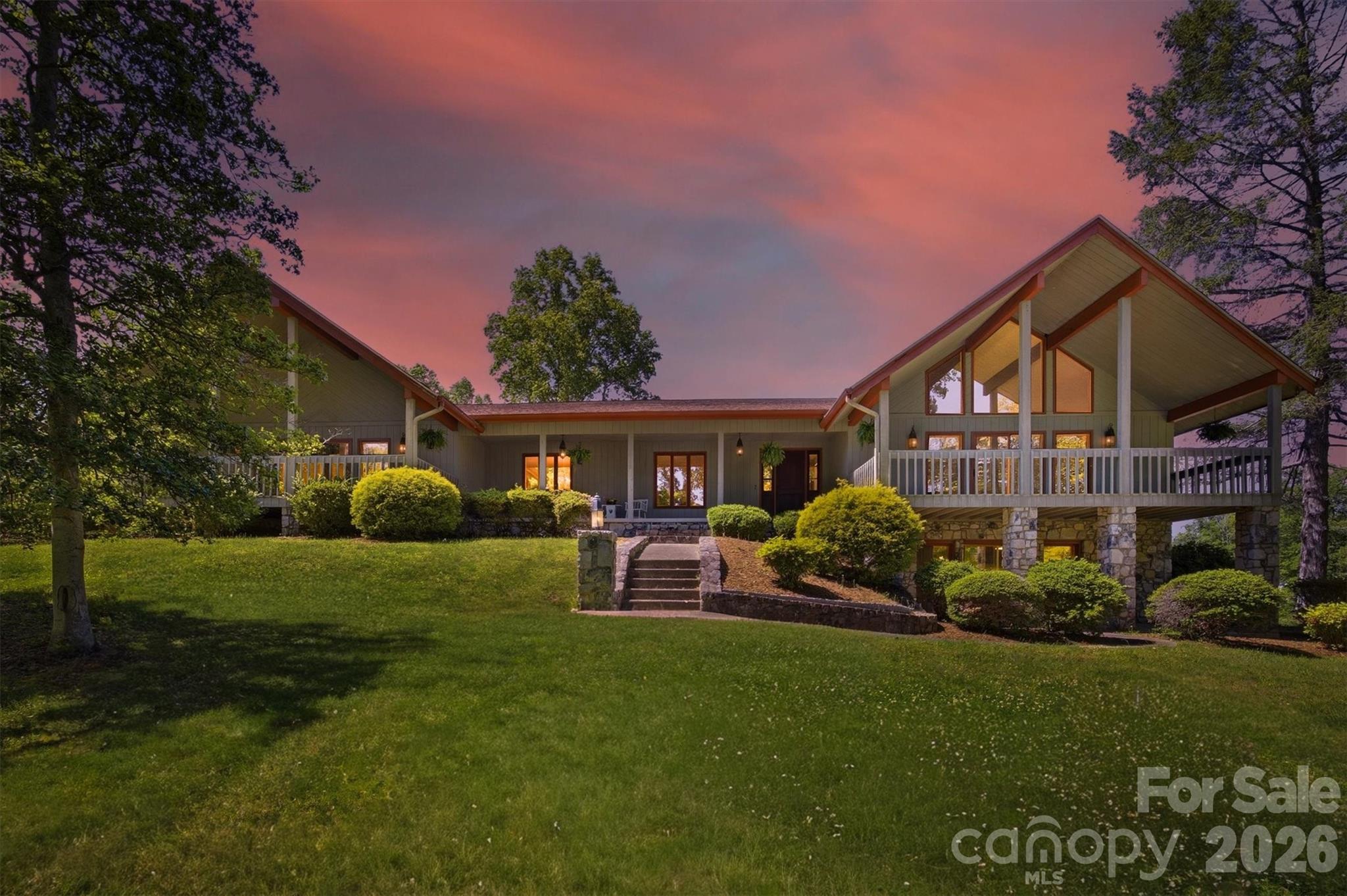 A Piece of Lenoir History, A True Mid-Century Modern Gem
This extraordinary property is more than just a home, it is a living piece of Lenoir’s architectural history.
Designed and built by renowned local contractor Bruce Barlow, who chose this very land to craft his own personal residence, the home has remained within the Barlow family ever since, preserving its original vision, character, and soul for decades. For the mid-century modern enthusiast or anyone who appreciates timeless craftsmanship, this is a once-in-a-generation opportunity to own something truly irreplaceable.
Set on over an acre of lush, usable land, the property offers a rare combination of privacy, natural beauty, and thoughtful design. The sweeping front and rear yard spaces provide room to breathe, play, and simply enjoy the serene surroundings, while mature trees frame the property with grace and seclusion. A new roof installed in 2023 ensures peace of mind from the moment you arrive.
The soaring oversized great room is anchored by a stunning Tennessee Fieldstone fireplace, a signature element that appears throughout the home and speaks to the craftsmanship of a bygone era. Exposed wood beam accents climb toward the vaulted ceiling, while an abundance of natural light pours through generous windows and flows seamlessly out to the covered back porch, blurring the line between indoors and out. The open floor plan concept creates an inviting, airy atmosphere that feels both grand and livable, ideal for entertaining or quiet evenings at home.
The covered back porch is nothing short of spectacular, a peaceful retreat where you can take in sweeping views of the rolling pastures and the majestic mountain ridgelines that define this corner of Western North Carolina. Whether enjoying a morning coffee or an evening gathering, this outdoor living space is destined to become the heart of daily life.
The generously sized dining area flows naturally from the main living space, reinforcing the home’s open and connected design. The kitchen features custom cabinetry that reflects the thoughtful detail put into every inch of this home, along with original appliances that remain fully functional, a charming nod to the home’s heritage. The breakfast nook offers one of the most coveted views in the house, overlooking the back porch and the pastoral landscape of rolling green fields and distant mountains beyond, a picture-perfect way to start every morning.
The primary suite is nothing short of extraordinary in scale and character. Exceptionally oversized, it offers a private sanctuary with room to spare,and retains its original en-suite bath complete with the original tub and shower insert, sink, and toilet, all preserved in working condition and full of vintage charm that perfectly complements the home’s mid-century personality.
The lower level expands the home’s versatility tremendously. A large, light-filled entertainment and game room features its own Tennessee Fieldstone fireplace and sliding glass doors that open directly onto a covered patio, connecting indoor recreation seamlessly with the outdoors. A fourth room offers tremendous flexibility, whether used as a home office, hobby space, or additional guest quarters. Perhaps most exciting is the substantial unfinished yet heated basement area, which provides exceptional storage capacity and holds significant potential for conversion into additional finished living space, a home gym, workshop, or media room.
Throughout the entire property, the Tennessee Fieldstone that appears in the fireplaces, exterior columns, foundation walls, and architectural details serves as the unifying thread, a material deeply rooted in the regional landscape that lends the home its unmistakable sense of place, permanence, and pride.
Additional updates include a heat pump replaced in 2019, one water heater replaced in 2024, and a new pressure tank. Ensuring that the home’s timeless character is supported by reliable modern systems.