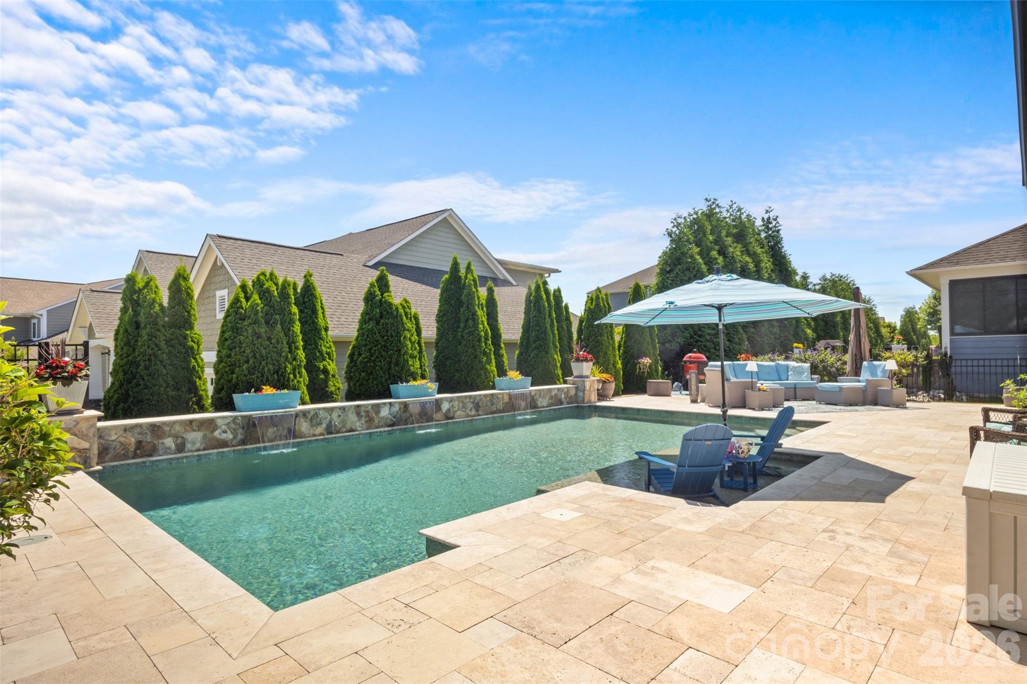 Step into luxury living with this exceptional home designed with two main floor en-suites. The backyard is truly an oasis, featuring an in-ground heated pool complete with a Baja-shelf perfect for easy wading, sunbathing, or relaxing with friends.  A spacious travertine patio surrounds the pool, along with a covered dining area ideal for outdoor meals and year-round enjoyment, all framed by a beautiful landscaped fenced yard.  Inside, the home offers an impressive layout with two main-floor en-suites, including a stunning primary retreat with a spa-like bathroom and an expansive custom closet system.  The second en-suite provides its own dedicated full bath, making it perfect for guests or multigenerational living. At the heart of the home is a dream kitchen built for entertaining, showcasing an extra-large island, gas-burning stove top, drop zone, and abundant cabinetry. The kitchen flows seamlessly into the dining area and sun-filled great room where plentiful natural light and backyard views create a warm, welcoming atmosphere.  A convenient half bath, along with a private office completes the first floor. Upstairs, you'll find two additional bedrooms, a full bathroom, and a large flex space ideal for a media room, game room, or additional office.  Every detail of this home has been thoughtfully designed to offer elegance, functionality, and resort-style living.  Nearby, enjoy Massey's amenities, including a lazy river, Olympic-sized pool, water slide, splash zone, and a community clubhouse with gym and media room.  This home has an unbeatable location close to Schools, Costco, Target, plenty of grocery stores, restaurants, MUSC Medical Center and plenty of shopping.