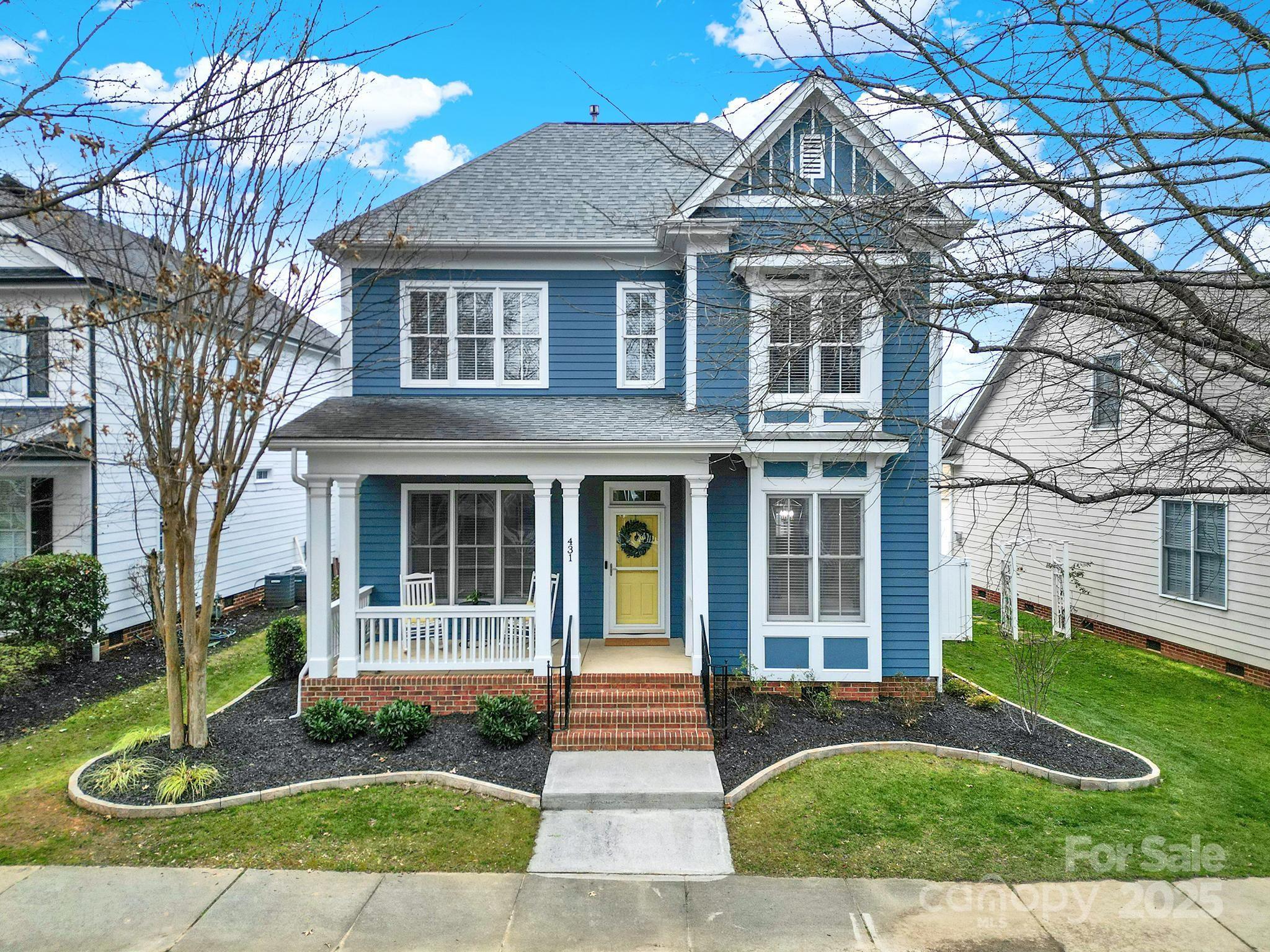 This beautiful two-story home offers classic curb appeal with its inviting rocking chair front porch, ideal for relaxing and enjoying the neighborhood. Inside, the freshly painted interior is accented with elegant Charleston moldings, creating a timeless atmosphere. This layout includes a primary bedroom on the main level. The spacious living room features a stunning stone gas fireplace, perfect for cozy evenings at home. With 4 bedrooms, or 3 bedrooms and a versatile bonus room, there’s plenty of space. This home also boasts a tankless water heater. A newly added set of back stairs provides easy access to the detached garage, which can be reached via an alley. Situated in a traditional neighborhood development on the Market Street side of the community, this home offers quick access to restaurants, fitness centers, scenic trails, and more. Whether you’re seeking comfort or convenience, this home has it all!