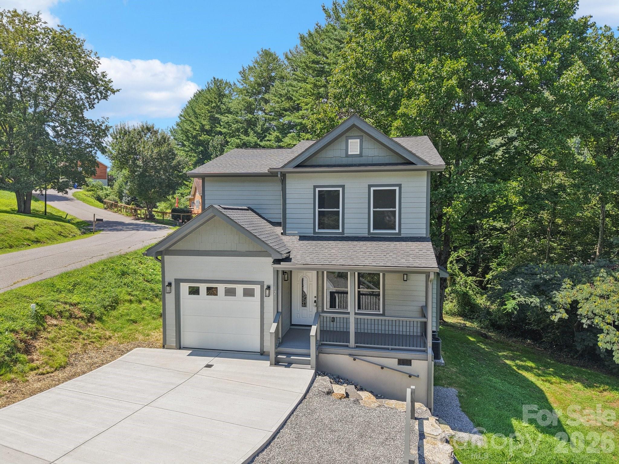 This brand new home comes with a REDUCED RATE as low as 5.375% (APR 5.719%) as of 04/22/2026 through List & Lock™. This is a seller-paid rate buydown that reduces the buyer’s interest rate and monthly payment. Terms apply; see disclosures for more information. Discover this stunning, brand-new 4-bedroom, 2.5-bath Modern Craftsman home, perfectly situated on a corner lot with convenient paved access for an easy commute to both Maggie Valley & Waynesville. The main level features a primary en-suite with a double vanity in the bath, offering comfort & privacy—a main-level guest half bath. The kitchen boasts soft-close drawers, elegant granite countertops, & sleek stainless steel appliances. The living room is anchored by a charming stone-surround gas fireplace, perfect for cozy evenings. Upstairs, 3 bedrooms & a convenient hall bath. A versatile bonus room provides endless possibilities as a playroom, workout space, or media room. This home is exceptionally well-insulated, including interior walls & ceiling, ensuring year-round comfort & quiet.  Additional features include a one-car garage, a welcoming covered front porch, an inviting open back deck, and a practical finished storage area, all contributing to this move-in-ready gem.