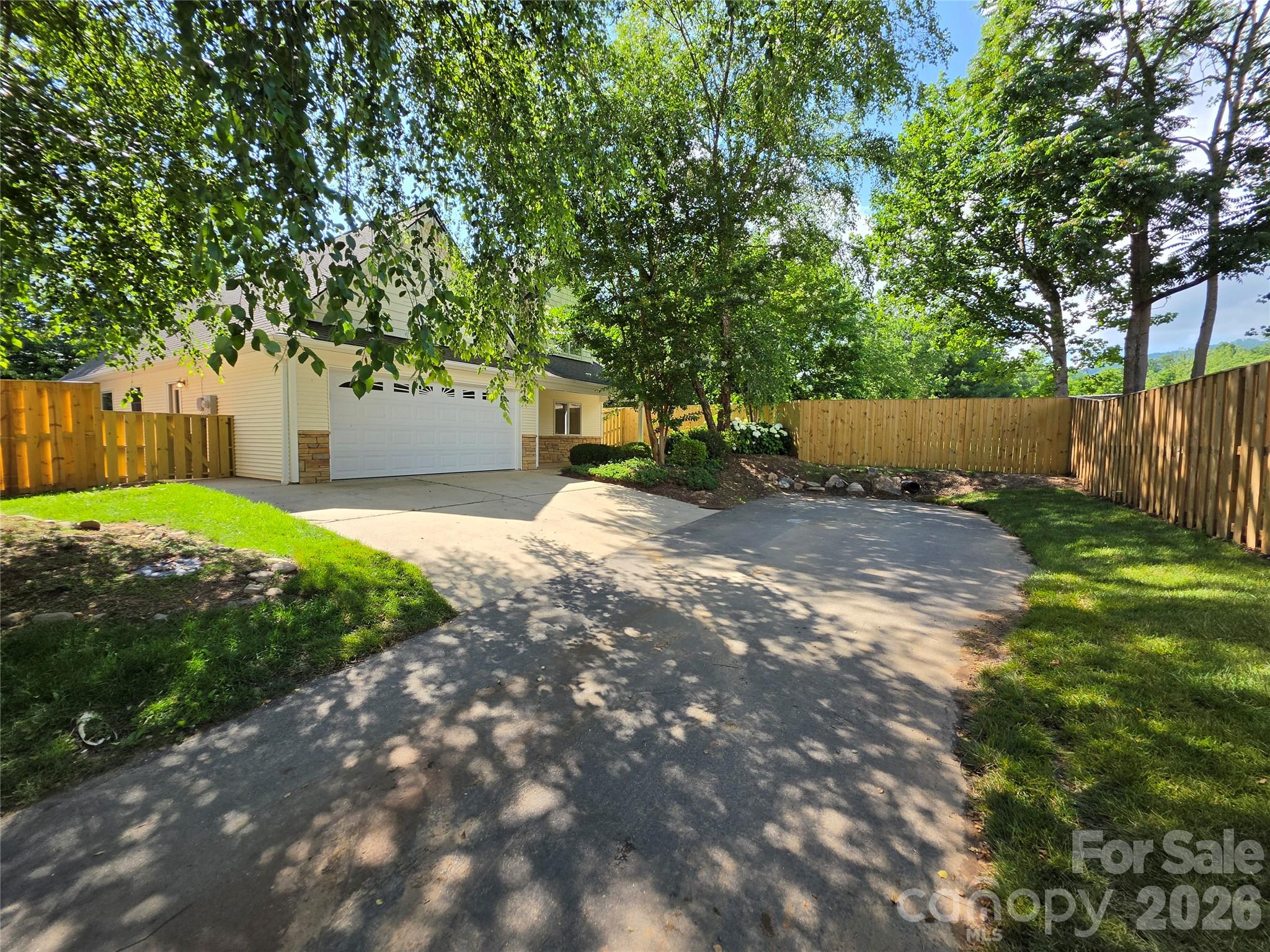 Beautifully renovated and ideally located in desirable Bee Tree Village, this home features true open concept main level living. The kitchen flows seamlessly into the dining and living area while the spacious primary suite, second bedroom, and full bath are all conveniently situated on the main level! Brand new appliances and a new HVAC system provide modern comfort and peace of mind. The four season room is bright and cheerful, opening from the main living space toward the peaceful and private outdoor patio. Thoughtfully landscaped planting beds surround the patio, which also features a flagstone area ideal for a fire pit and gathering with friends and family. Upstairs, an expansive bedroom suite with a full bath offers outstanding flexibility for guests, private office, or a work from home space. The Bee Tree Village community is known for convenience to Asheville and Black Mountain without city taxes and pretty, walkable HOA-maintained streets. Be sure to check out the virtual tour!