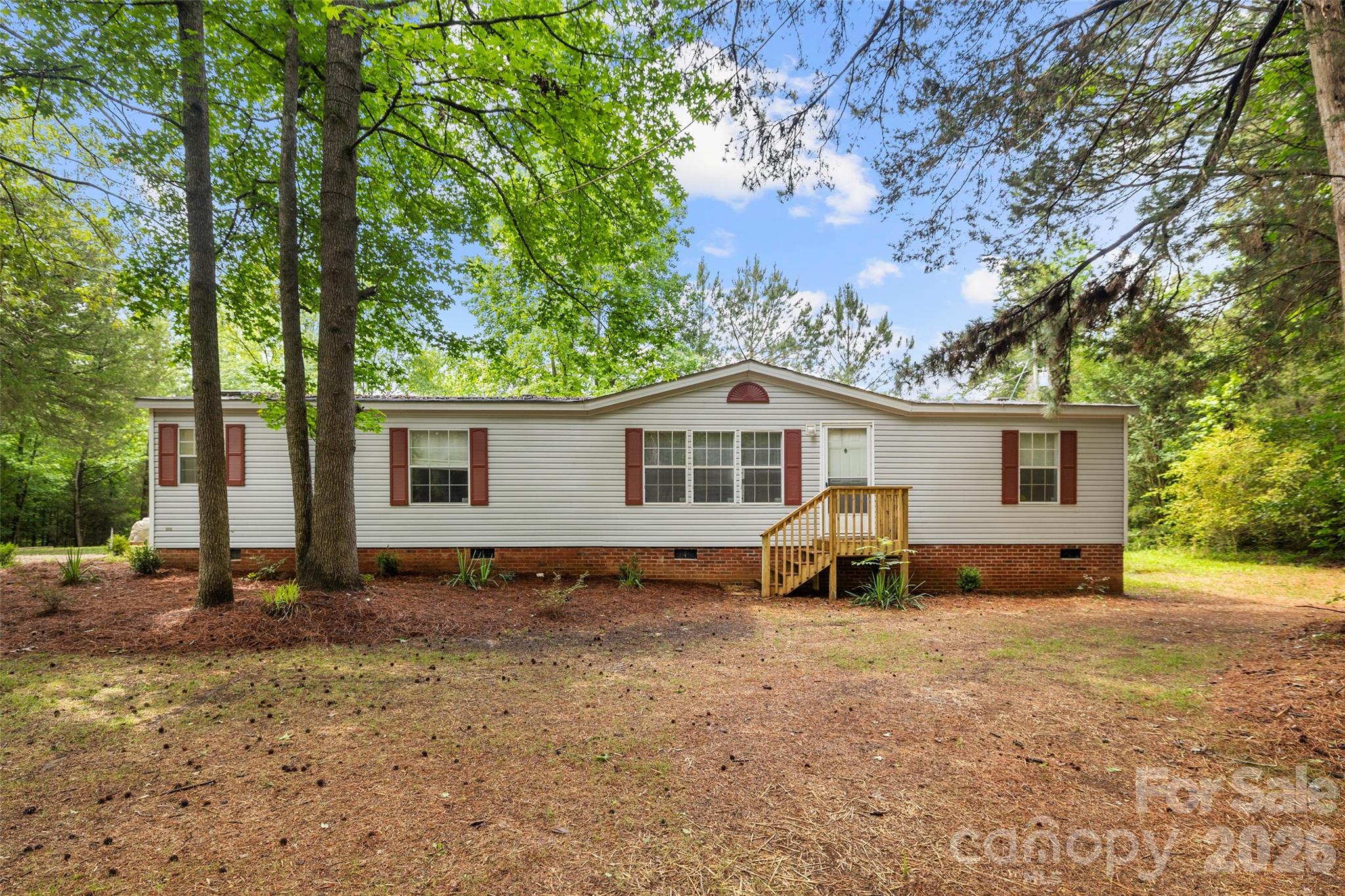 Welcome to this charming 3-bedroom, 2-bath well-maintained home. A long gravel driveway leads the way, winding through the trees, creating a private and peaceful setting for you to enjoy. This home offers comfortable living spaces and a versatile bonus room that is perfect for an office, study, craft room, or flex space. Surrounded by mature trees and at just under 2.5 acres, this property offers privacy and a serene natural backdrop while still being conveniently located near schools, shopping, Interstate 77 and everyday amenities.