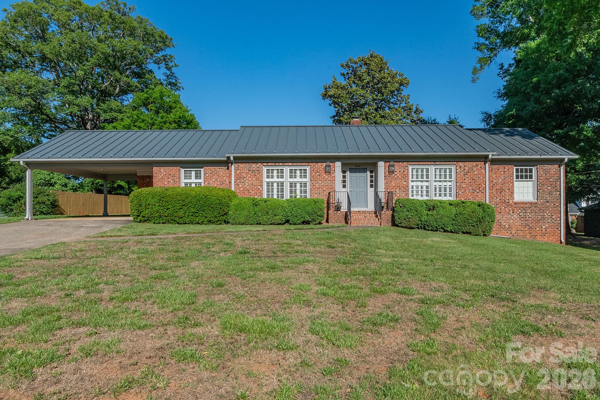 Beautifully maintained and full of charm, this home features a lifetime gable metal roof, hardwoods throughout, fresh paint, interior shutters, and stunning custom cabinetry in the kitchen, bathrooms, and mud room. The kitchen also offers a spacious pantry and a charming pocket door leading into the den, perfect for entertaining or cozy nights in.

As a true testament to the care poured into this home over the years, the custom front porch light fixtures were specially made in Charleston and have developed a timeless patina with age.

The primary suite features a custom closet organization system, while the basement provides incredible flex space ideal for hobbies, gardening projects, storage, or a workshop complete with a work table that will remain with the home. Outside, enjoy ample parking and yard space in a welcoming neighborhood loved by all.

Perfect for first-time home buyers, downsizers, or anyone looking for a wonderful opportunity. Don’t let this one pass you by!