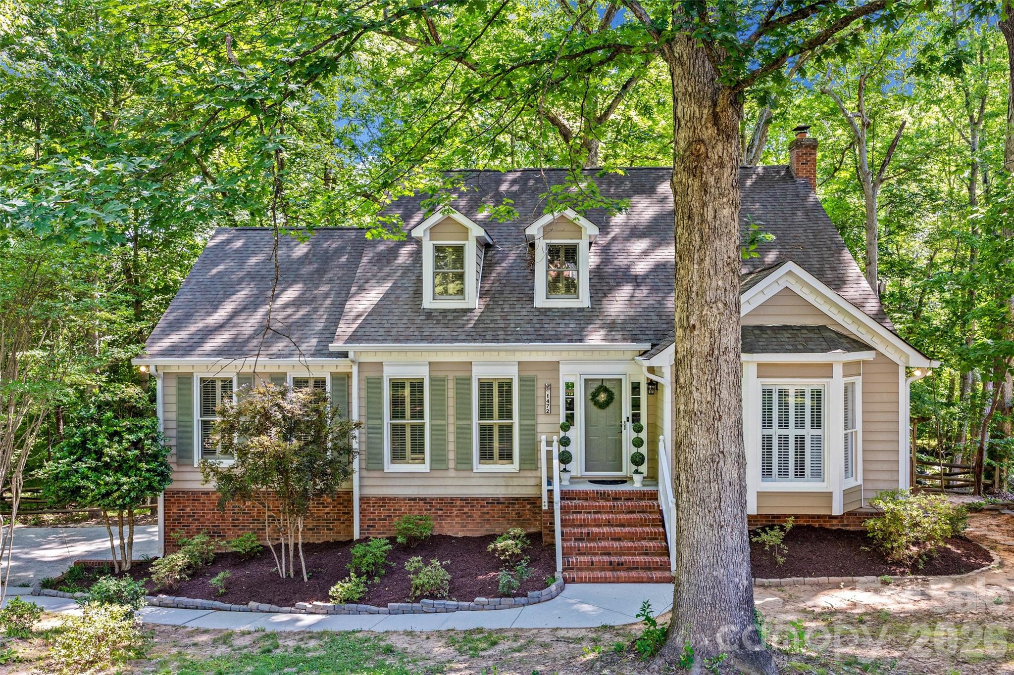 Tucked beneath a canopy of mature trees on nearly an acre, this beautifully renovated cottage-style home in the heart of Fort Mill offers the perfect blend of charm, privacy, and modern updates. From the moment you arrive, you’ll feel like you’ve discovered a hidden retreat in the woods—yet you’re just minutes from shopping, dining, and all that Fort Mill has to offer.

Inside, the open floor plan is filled with natural light and scenic wooded views that make the home feel like a peaceful treehouse getaway. The updated chef’s kitchen features abundant storage, stylish finishes, and flows seamlessly into the dining, living and even a separate office space —perfect for entertaining, working from home  or everyday living. The spacious primary suite on the main level includes a beautifully updated ensuite bath and his & hers closets, while upstairs offers 2 additional bedrooms with plenty of space for family or guests.

The fully finished basement adds incredible flexibility with a full bath and room for a gym, media room, playroom,  guest retreat, or hobby space. Oversized 2-car garage provides exceptional storage and room for vehicles, tools, and outdoor gear.

Step outside and enjoy the ultimate outdoor lifestyle with an expansive patio, gazebo, firepit area, and multiple entertaining spaces overlooking your own wooded explorer’s paradise. Whether you’re hosting friends, roasting marshmallows, or simply enjoying quiet mornings surrounded by nature, this backyard is something special.

Located in an excellent Fort Mill location with top-rated schools, this one-of-a-kind property offers the rare combination of updated living, privacy, character, and space both inside and out.