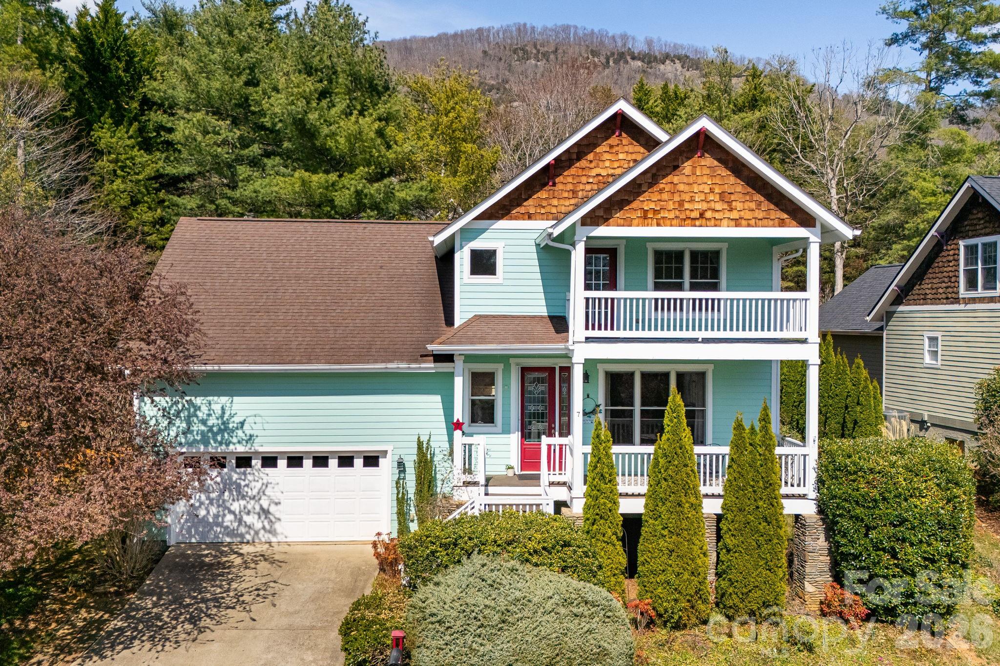Classic craftsman home in the coveted Eastwood Village neighborhood!  Conveniently located less than ten minutes from downtown Asheville and only 2 miles from the Blue Ridge Parkway, 7 Oakhaven Terrace features year-round mountain views, multiple outdoor living spaces, and a low maintenance lot with mature landscaping.  The covered front porch welcomes you into an open floor plan flooded with natural light, 9' ceilings, and a gas fireplace.  The living area flows seamlessly into the generously sized kitchen with newer granite countertops and stainless appliances.  The primary suite is located on the main floor and has vaulted ceilings, a jetted tub, walk-in shower, large closet, and private access to the rear deck with a hot tub.  Upstairs you'll find a full bathroom and two bedrooms, one of which has a large covered balcony with beautiful year-round mountain views.  With restaurants, a grocery store, and well regarded Reynolds High and Middle Schools within easy walking distance, this one checks all the boxes!