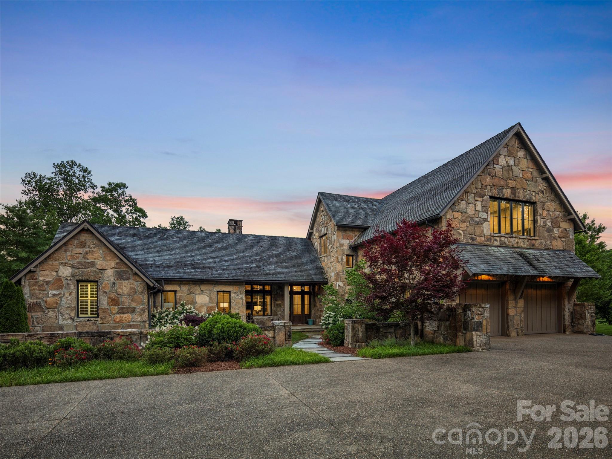 Nestled within the gates of the ultra-exclusive Cliffs at Walnut Cove, this estate is a masterwork of rustic elegance and refined luxury. The property is perfectly poised on a premier homesite between the 14th and 15th greens of the signature Jack Nicklaus-designed golf course. This rare location offers a front-row seat to the prestigious Biltmore Championship, backdropped by manicured fairways and breathtaking Blue Ridge mountain vistas.  From the moment you arrive, the estate commands attention with its striking architectural artistry. Built to the highest standards, this superior Glenwood home design features massive, solid chiseled stone elements that evoke the historic grandeur of the nearby Biltmore Estate, establishing an immediate sense of permanence and prestige.  Inside, the interior is defined by magnificent soaring beams and rich, hand-selected floors crafted entirely from reclaimed red oak wood, infusing the space with matchless character and history. The home’s crown jewel is the expansive, enclosed all-season porch. Designed for year-round enjoyment, this spectacular space seamlessly blurs the line between indoor luxury and outdoor majesty. It provides a private, dramatic vantage point to take in the sweeping mountain landscape and the rolling greens below.  Spanning three bedrooms and three-and-a-half beautifully appointed baths, the floor plan is thoughtfully zoned to effortlessly balance grand-scale entertaining with intimate, everyday living.  Beyond your private oasis lies The Club Village, a magnificent European-style campus that serves as the social heart of the community. Here, you can dine at the Tudor-style Tavern, unwind in the new open-air beer garden, or access the sprawling Wellness Center. This 18,000-square-foot facility features a heated indoor lap pool, a Junior Olympic outdoor pool, Har-Tru tennis courts, a luxury spa, and miles of private hiking trails, all adjacent to the nearby Pisgah National Forest. Life here offers the perfect harmony of absolute security, elite recreation, and total privacy, all just minutes from downtown Asheville.