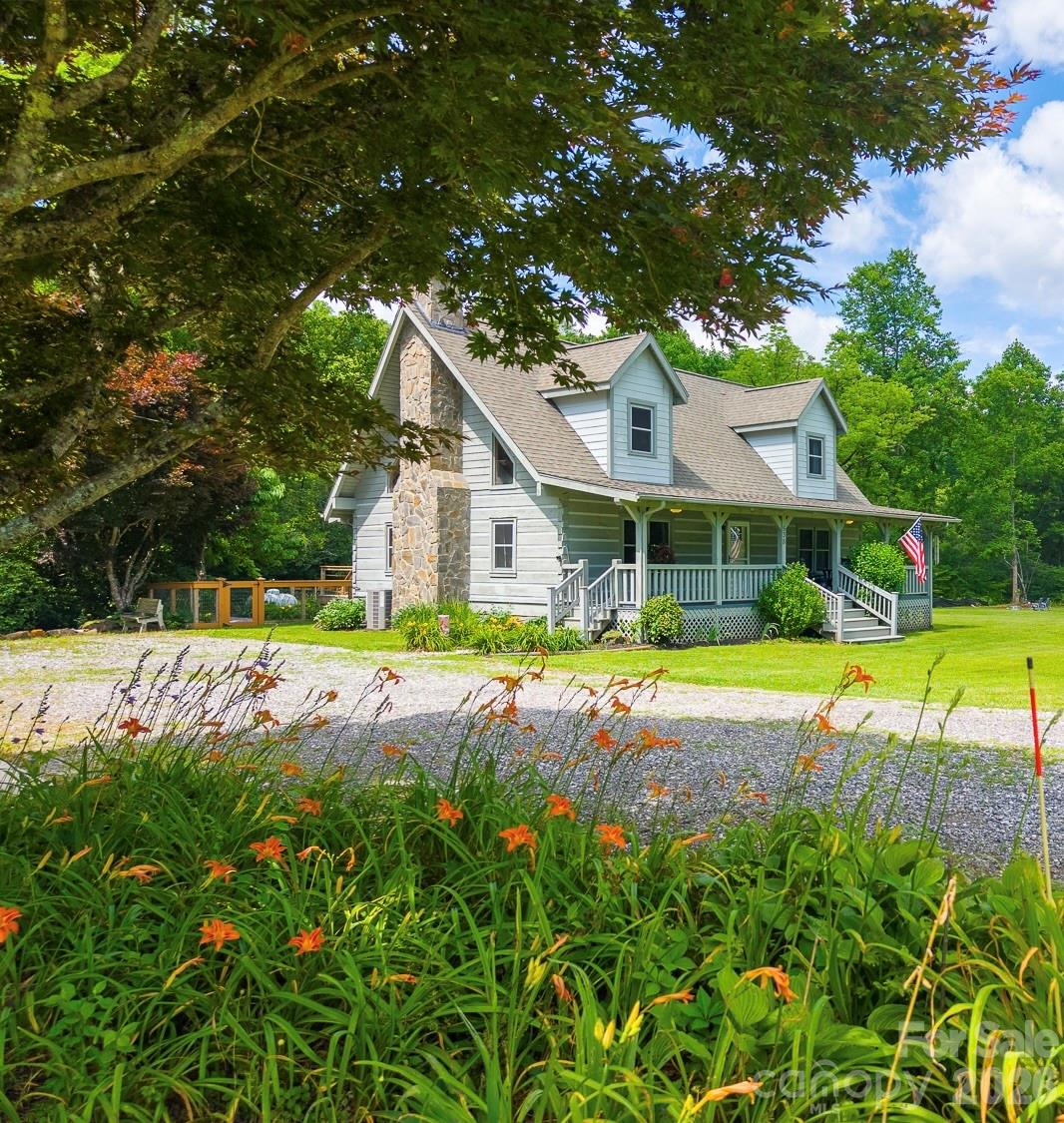 Wouldn't you love a cabin with creek frontage the length of the property, 2 car garage w/single carport, level yard, fenced yard for fur babies, easy access and pastoral views. This one will not disappoint. You will enjoy sitting on the covered front porch, rocking and listening to the sound of the creek or maybe take in the sun on the back deck while watching the kids or pets play. Enter into the office space or reading nook, complete with gas stove for cold winter evenings and at the end a pantry with freezer. Head into the large country kitchen that any cook will love for preparing meals.  Kitchen and dining are open with the great room and stone fireplace with gas logs for your convenience and enjoyment. Send the guests upstairs to the open loft bedroom with large walk in closet and ensuite bath. Entering the primary bedroom you will find a laundry/powder room on the left. The primary bedroom is spacious with a huge walk in closet and the ensuite bath is complete with double sinks and linen closet. This one is a jewel.
