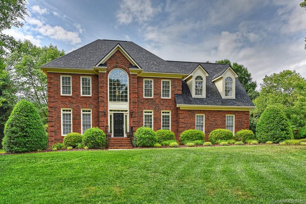 Amazing full brick with park like setting! Features include side load garage with workshop, spacious deck overlooking private back yard, 4 bedrooms, 2.5 baths, (4th bedroom can be a LARGE bonus room) site finished hardwoods on most of main, wood burning fireplace and custom built-ins in great room, kitchen has granite counters, tile back-splash, 42 inch cabinetry and gas range/oven, master bedroom features tray ceiling and recessed lighting. Beautiful lot on nearly an acre! Weddington schools!