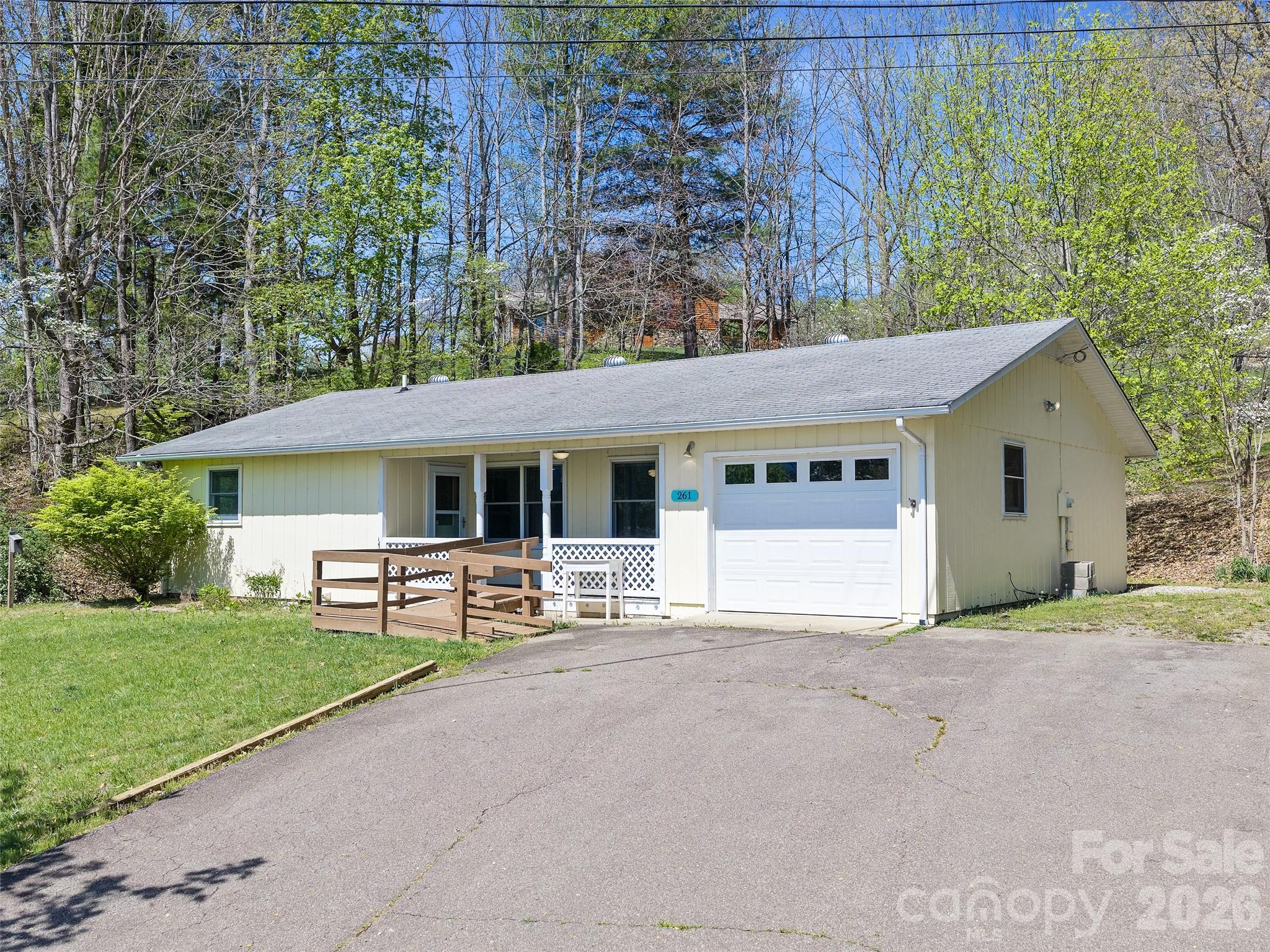 Private mountain retreat just 5 minutes from downtown Burnsville! With year-round long-range views of the
Black Mountains and Mt. Mitchell from the front porch, this is truly a unique offering. Situated on a gently sloped  2.28 acres in a peaceful setting, this one-level ranch offers a comfortable mountain
lifestyle. The home features an open floorplan that includes 2 bedrooms and 2.5 baths. Recent improvements
include a new GE refrigerator, and stove, and a brand new vapor barrier in the basement. The property
layout, along with 2+ acres, provides rare flexibility. The existing well and septic are located near the
home, while the lower 1+ acres is open and cleared, offering strong potential for a second homesite or
small family compound (buyer to confirm). Paved access to the South and a 20-foot easement along the
eastern boundary support additional access points. An excellent opportunity for future expansion! Whether
you're a nature lover, compound seeker, or savvy investor, this property offers affordable mountain living
with land and iconic views—just minutes from town and a compelling alternative to Asheville-area pricing.