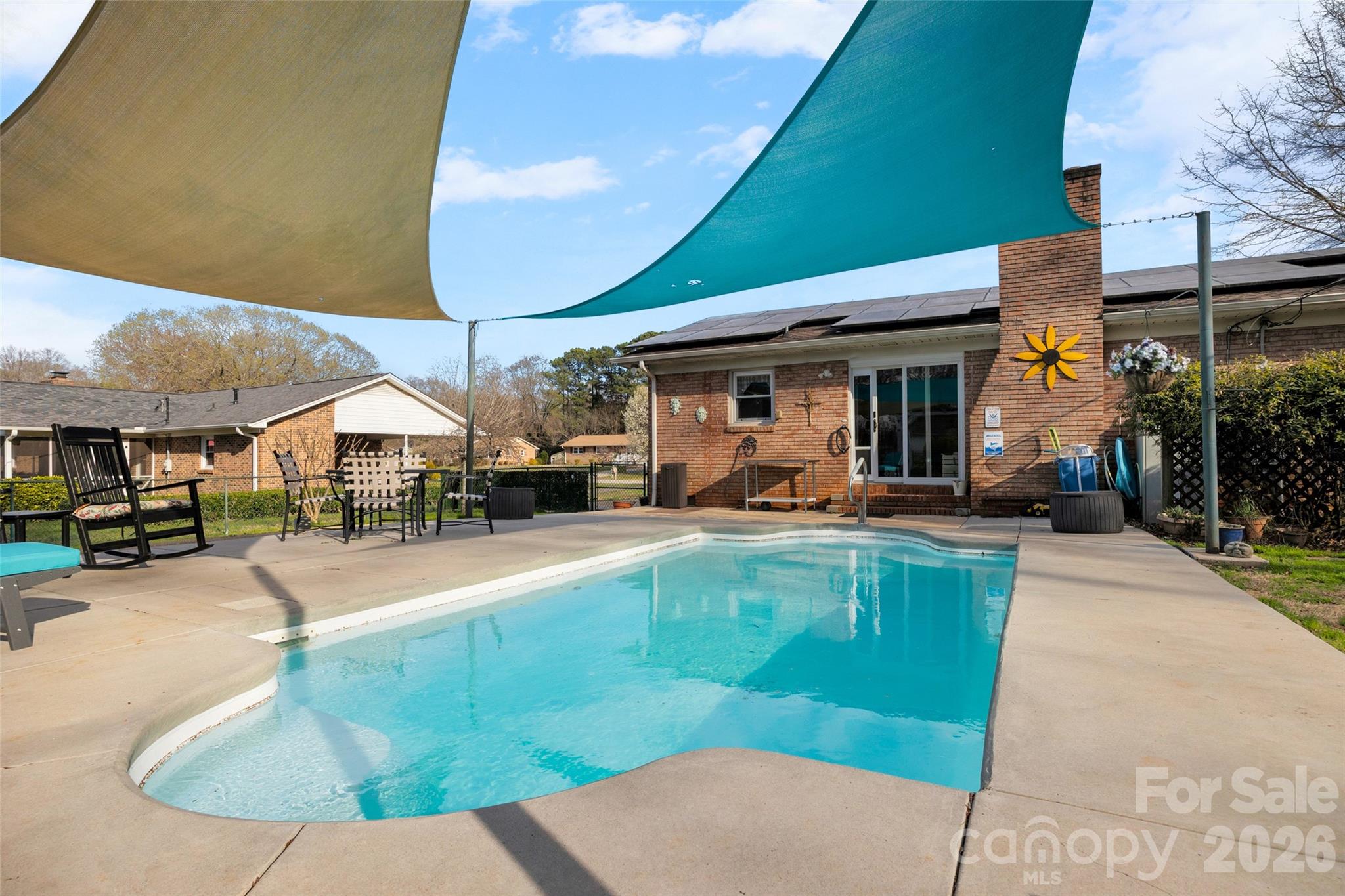 Look at this beautiful pool with sunshade. Come home and relax next to your sparkling salt water in ground pool! The pool area has lots of room for entertaining by the pool. Then relax out front on the large porch and enjoy your coffee or a glass of sweet tea. There is a detached 2 car garage with extra storage or workshop area, and more storage on the back of the garage. The home has an extra room off the kitchen, used as an office, or extra entertaining, school area, den or whatever you desire. The back yard is fenced in for security of the pool and for your four-legged babies. The greenhouse does not convey. The home also has solar panels to offset the cost of utilities. This home is not in the city limit, so only county taxes!  HOA is voluntary and is only $25.00 a year. With all this home has to offer, come quick! The home is located in the Cato Estates off Celanese and off Twin Lakes Road.