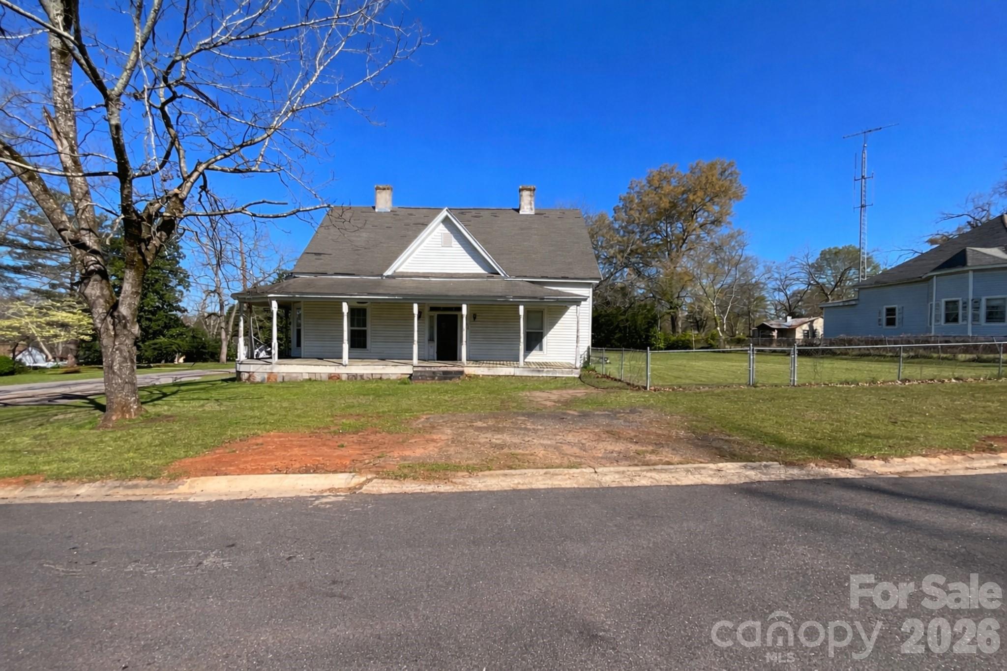 Welcome to this charming farmhouse-style home featuring 3 bedrooms and 2 full bathrooms, offering a great blend of character, space, and opportunity. This home features a functional layout with a spacious living area, full kitchen, and generously sized bedrooms—perfect for comfortable everyday living.
Enjoy relaxing on the classic covered front porch, adding timeless curb appeal and a warm, inviting feel. Situated on a large lot, the expansive yard provides plenty of space for outdoor enjoyment, entertaining, or future enhancements. This property presents a great opportunity for both homeowners and investors alike. With solid bones and room for updates, it’s ideal for a buyer looking to personalize their home or an investor seeking value-add potential. Suitable for a primary residence, rental, or light renovation project. Conveniently located near local amenities while maintaining a quiet residential setting. Don’t miss your chance to own a property with charm, space, and upside potential!