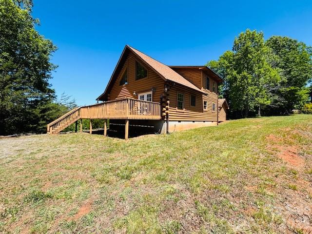 Carolina on your mind? Private gated community of South Mountain Peaks features paved roads nestled in mountain views! Discover your love for the mountains in this 2BD/2BA cabin has 1,512 square feet waiting for you to call it home! Covered front porch welcomes you inside to a spacious family room with the floor to ceiling stone FP/gas logs being the center of attention! Dining area has French doors that open to the side deck for entertaining! Kitchen has ample cabinets, breakfast bar, and a pantry! Main floor bedroom offers two double closets. Main floor full bath has a tub/shower, linen closet, and a stackable W/D hookup in it's own closet! Upstairs to the primary bedroom and walk-in closet. Primary bath features a walk-in shower and linen closet! There is a matching storage building next to the cabin for additional storage. Convenient location to NC Highway 226, US Highway 64 to the west and US Highway 74 further south. Located within minutes of Cherry Mountain, South Mountain State park, and Yogi Bear's Yellowstone Park whether it's your weekend getaway, investment or rental opportunity, or a fulltime retreat! Schedule your appointment soon!