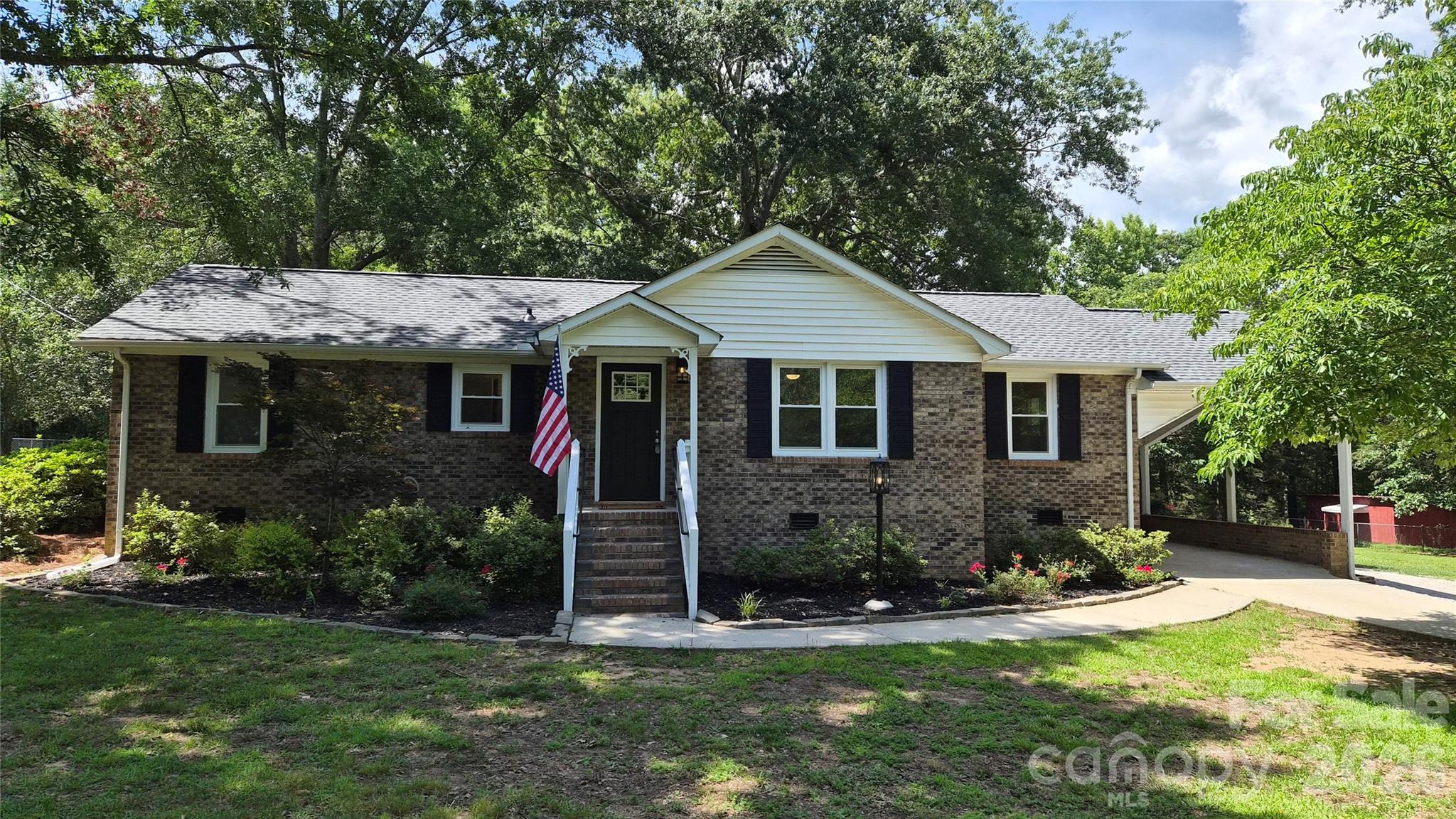 Recently refreshed brick ranch on 1.44 acres in a quiet, country setting.   The home features new flooring, kitchen appliances, HVAC system, water heater, light fixtures, plumbing fixtures, and more. The large, fenced yard has beautiful mature trees and landscaping and out back there is a small barn, metal storage building, storage shed, and two detached carports.