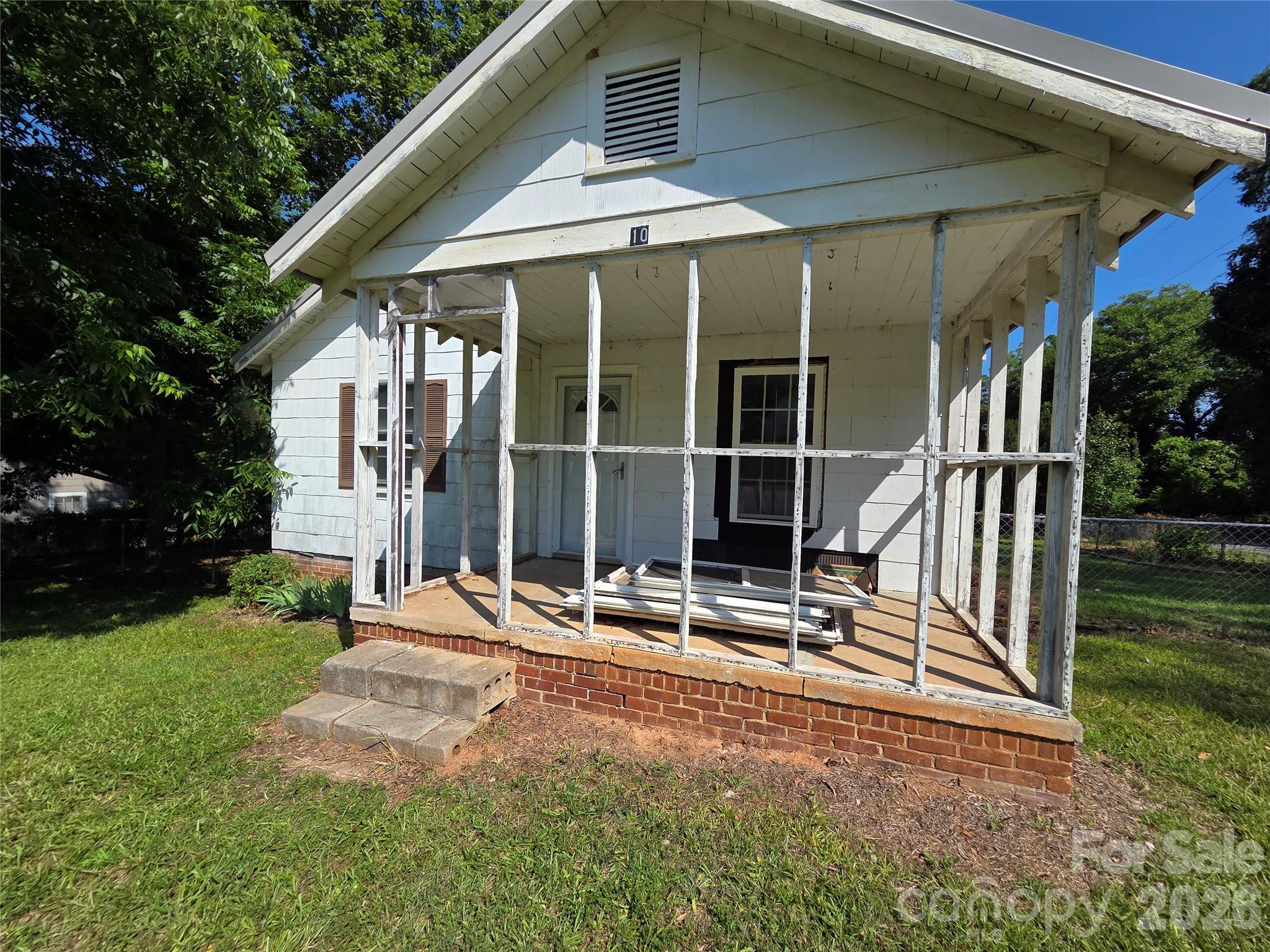1942 Cottage on .30-Acre Lot — Full Gut Renovation / Rebuild Opportunity

Calling all investors and renovators: this 2-bedroom, 1-bath cottage, built in 1942, sits on a spacious .307-acre lot shaded by mature trees. The property offers a rare opportunity to fully rebuild and restore a home with great bones and classic character — original hardwood flooring, a brick chimney, and a covered/screened front porch with metal roofing hint at the charm waiting to be uncovered.

This home is mid-renovation and being sold as-is. Interior demolition is in progress, with several rooms down to studs and insulation, and the kitchen and bathroom are original/dated and will need full updates. Roof and electrical service were replaced in 2017; however, electrical and heat are currently not turned on, and buyers should anticipate completing a substantial renovation from this stage forward.
This is a project for an experienced investor, contractor, or buyer prepared to take on a full rebuild. Exterior siding material has not been verified by seller; buyer to confirm during inspection period.
Schedule your showing today to see the potential firsthand.