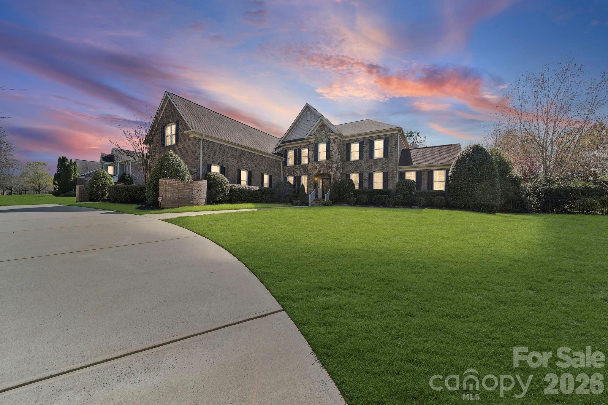 5 BD | 5.5 BA | 8,500+ Sq Ft | Finished Basement | Private Pool & Spa | Sauna | Home Gym | Yoga Room | 0.70 Acres | Marvin Ridge Schools

There are homes. There are luxury homes. And then there is 6009 Autumn Blossom Lane — a rare private estate in the heart of Marvin Creek where resort-style living meets the warmth of a true family home, steps from top-rated Marvin Elementary and minutes from Marvin Ridge's 9/10-rated middle and high schools.

Set on a lush, private 0.70-acre lot, the timeless all-brick exterior, sweeping circular driveway, and manicured grounds set a tone of quiet elegance before you ever reach the front door. Newly upgraded lighting and ceiling fans throughout give this stunning home a fresh, modern energy that feels even better in person than it photographs.
Inside, a soaring two-story foyer with a graceful curved staircase makes an immediate impression. Rich hardwood floors flow through the main level — past a French door study, a formal dining room, and into a gourmet kitchen with custom cabinetry, granite counters, premium appliances, and a sun-drenched breakfast nook overlooking the backyard. Upstairs, the primary suite is a genuine five-star retreat with dual vanities, a deep soaking tub, and a frameless walk-in shower. Four additional bedrooms and 5.5 baths provide exceptional comfort throughout.

Then there is the backyard — and it deserves its own conversation.

Completely private and resort-designed, this outdoor sanctuary is unlike anything else in this price range:

Private pool & spa — totally secluded, resort-quality 
Sauna — your personal relaxation sanctuary 
Dedicated home gym — no membership required 
Private yoga & wellness room — your daily reset at home 
0.70 acres of lush, private Carolina landscape

This is not a feature list. This is a lifestyle most people only experience on vacation.

The fully finished basement adds another complete level of living — home theater, guest suite, game room, Home Gym & Sauna — whatever your life calls for. And all of this sits in Marvin Creek, one of the Charlotte area's most coveted communities, with Marvin Elementary just 0.4 miles away and Marvin Ridge Middle and High School both rated 9/10.

Homes of this caliber, refreshed and relaunched at their absolute best, simply do not come available often.

This is your moment. Welcome home.
