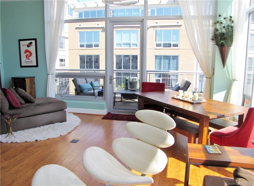Corner top-floor condo w/elegant furnishings, floor-to-ceiling windows w/motorized shades, 10' ceilings, breathtaking views, hardwoods and tile, high-end cabinets and faucets. Kitchen w/SS Viking appliances (gas range and convection oven), Sharp microwave, granite counters, mosaic tile backsplash. Walk-in closet w/built-in organizer. Bath w/heated floors and large shower. Roomy balcony w/grill. 1 reserved parking space in deck. Building has clubhouse, gym, rooftop pool and lounge w/grill area.